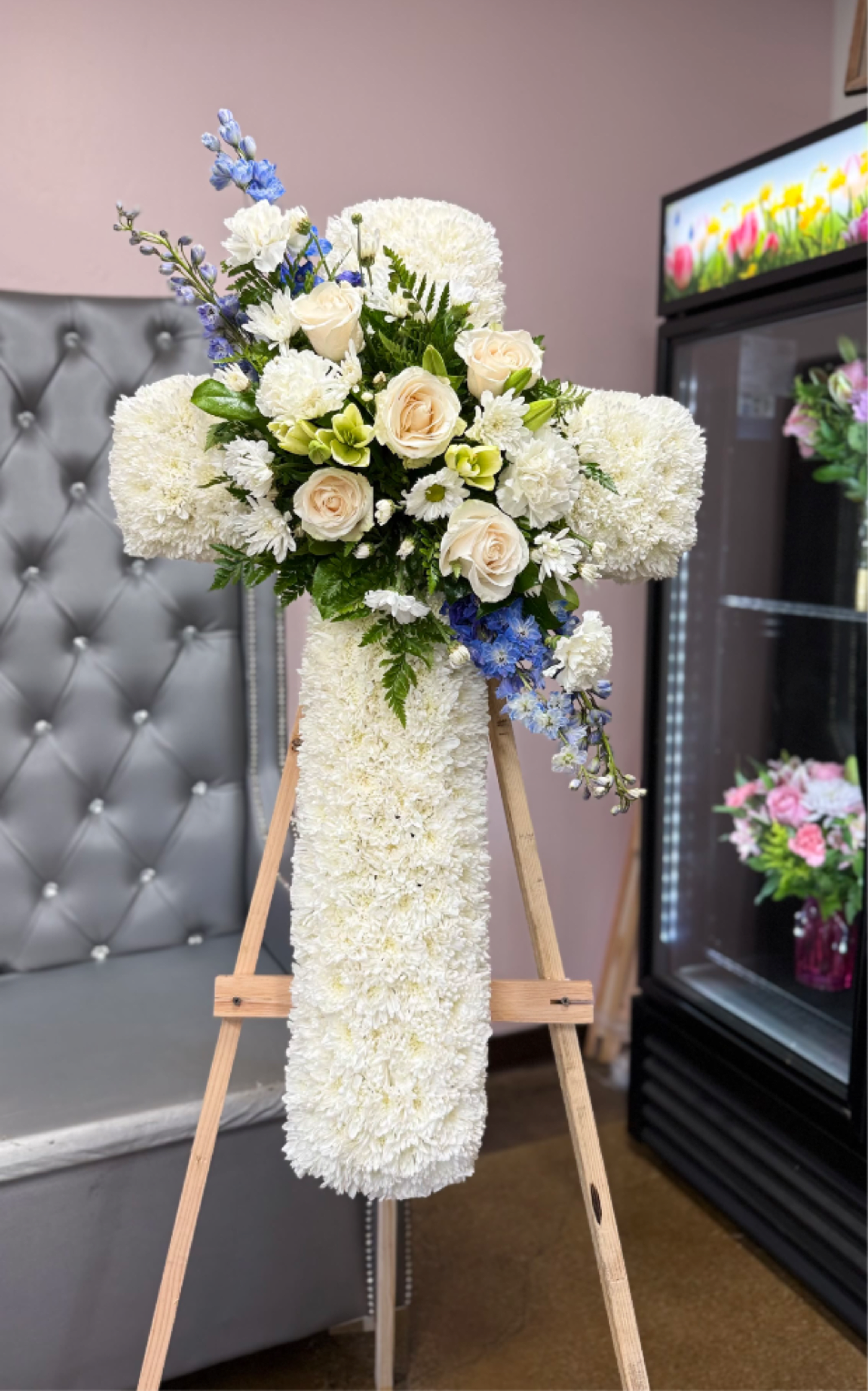 Peaceful Sympathy Cross - Measures approximately 34" in height and includes a 6-ft easel. Features white flowers with subtle blue accents. Med size cross