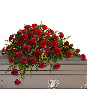 Red carnation spray on a gray casket