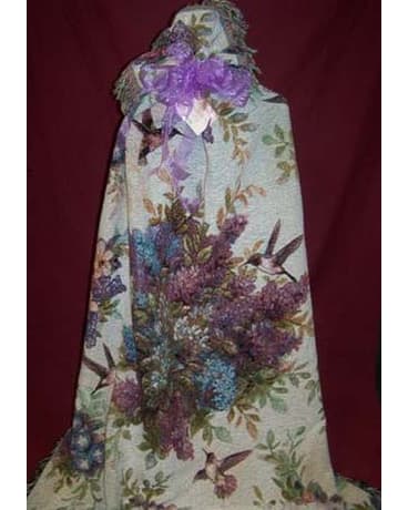Floral-patterned gift bag with a purple ribbon bow