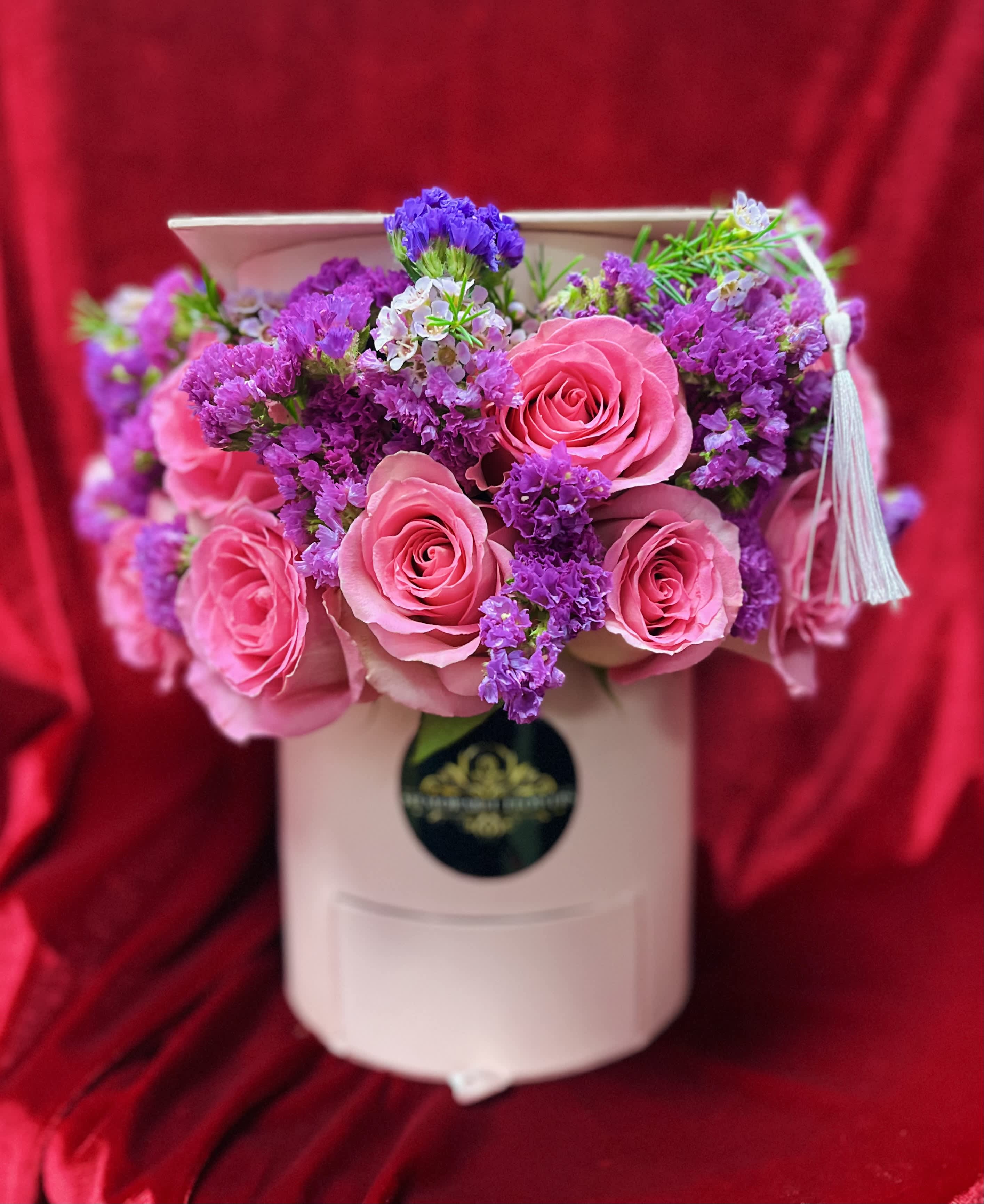 Grad Flower Box - Small graduation flower box .  Includes roses and additional fillers.  Box color can vary.  Pink, black, or white box available.  If you need an specific color box or roses please add details in the comment section. Or simply call us after purchasing your order @ 661-742-7151. 