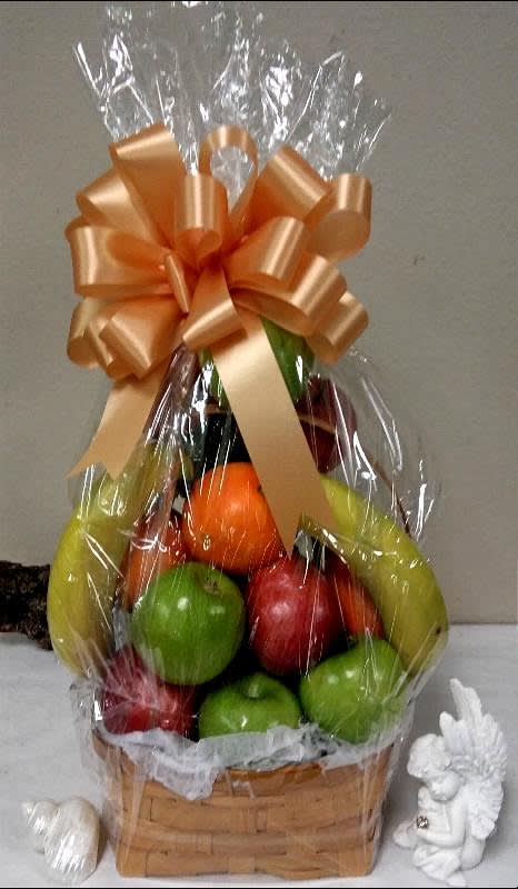Basket of assorted fruit wrapped in clear cellophane with a large bow