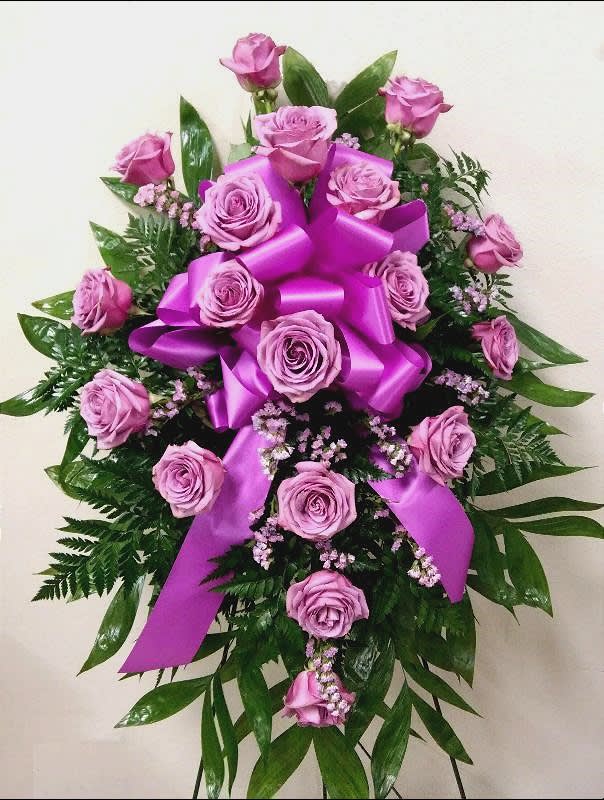 Pink rose spray with a large purple ribbon bow