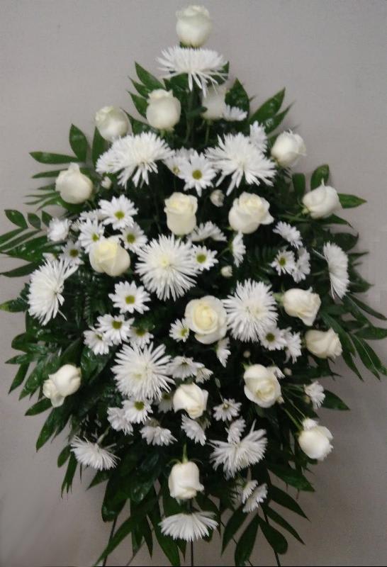 White floral funeral spray with roses and daisy-like blooms