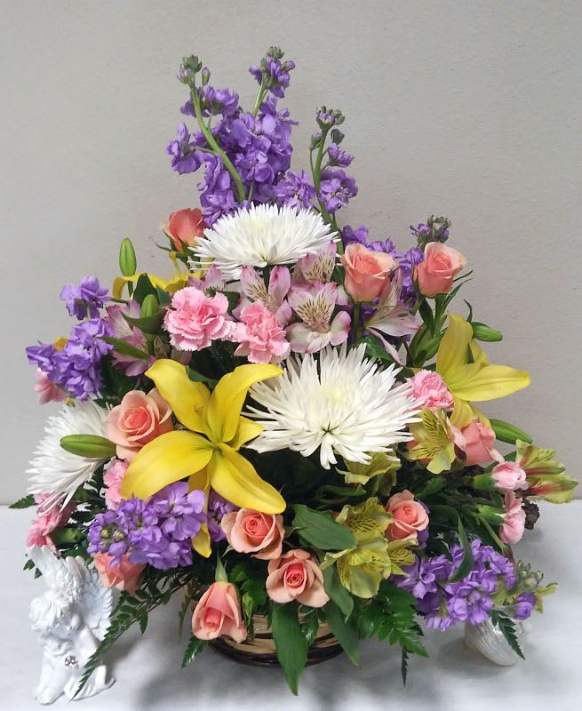 Mixed bouquet with yellow lilies, pink roses, white spider mums, and purple flowers