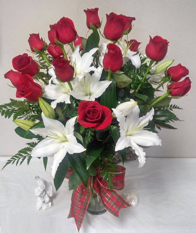Bouquet of red roses and white lilies in a glass vase