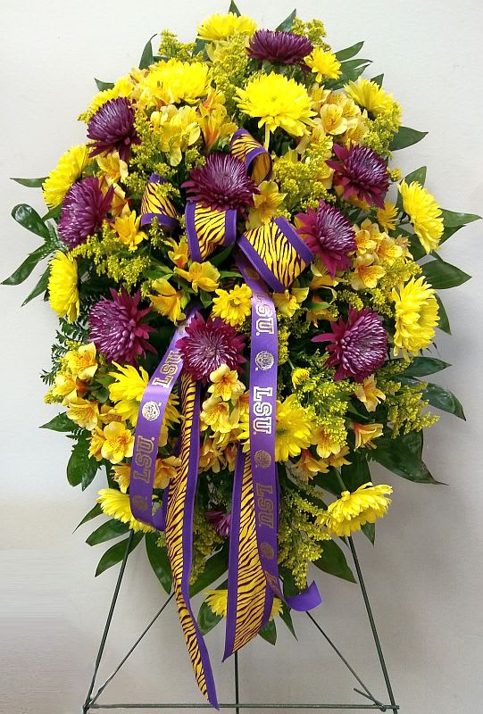 Large yellow and purple floral standing spray with LSU ribbons