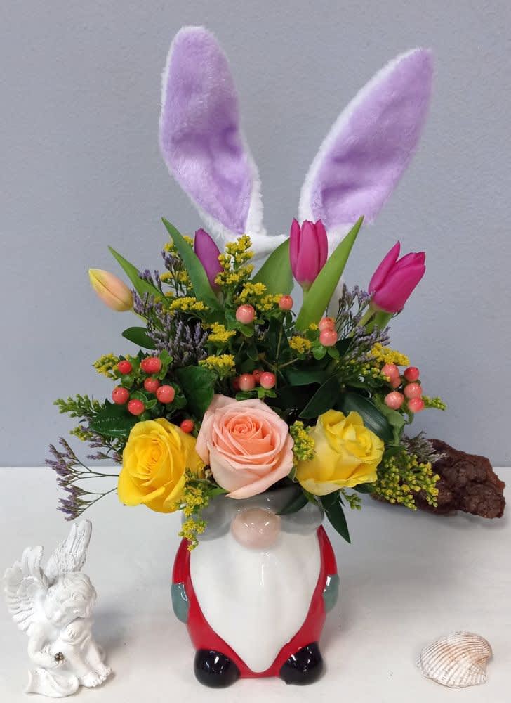 Floral arrangement in a bunny-shaped vase with tulips, roses, and bunny ears