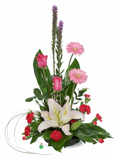 Tall pink and white arrangement with lilies, roses, gerbera daisies and carnations in a low black container