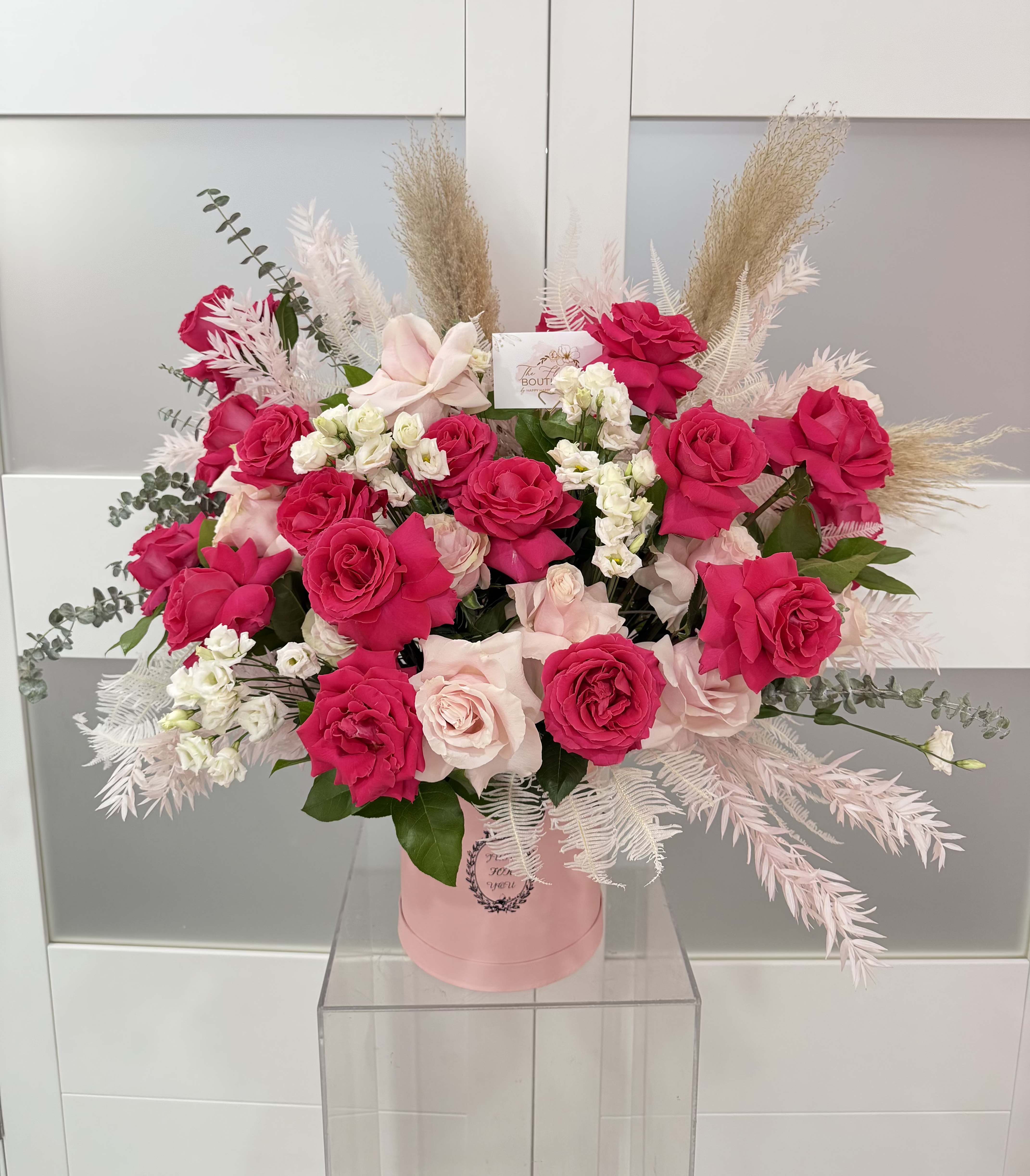 Pink and white rose bouquet in a pink hat box