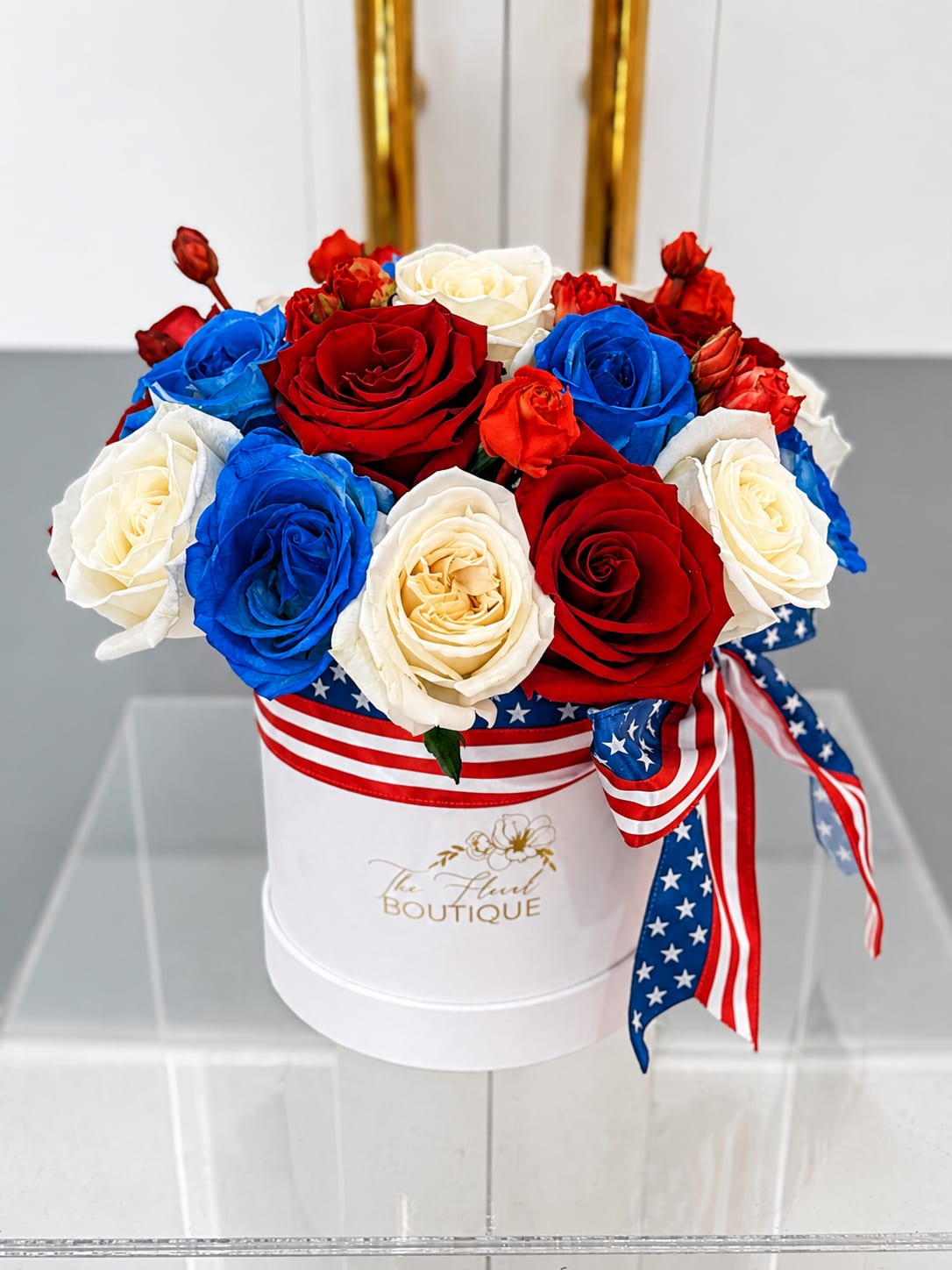 Stars &amp; Stripes Rose Box - Celebrate America with our Stars &amp; Stripes Rose Box, a timeless arrangement featuring premium red, white, and blue roses beautifully designed in our signature white luxury hat box and finished with a patriotic ribbon. Perfect for honoring military service members, veterans, first responders, Independence Day celebrations, Memorial Day, the Fourth of July, or sending a heartfelt gift to someone who proudly loves the USA.  Each arrangement is handcrafted using the freshest premium roses for a stunning presentation that makes a lasting impression.  Features:  * Premium red, white, and blue roses * Signature luxury hat box * Patriotic ribbon accent * Rose colors and ribbon can be customized upon request  Ordering Information: To ensure the freshest blooms and allow time for design, we recommend placing your order at least 24 hours prior to your desired pickup or delivery date. 