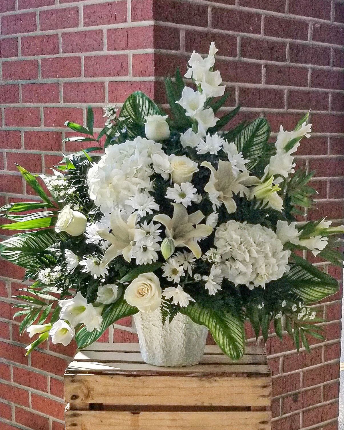 White floral standing spray in a white vase