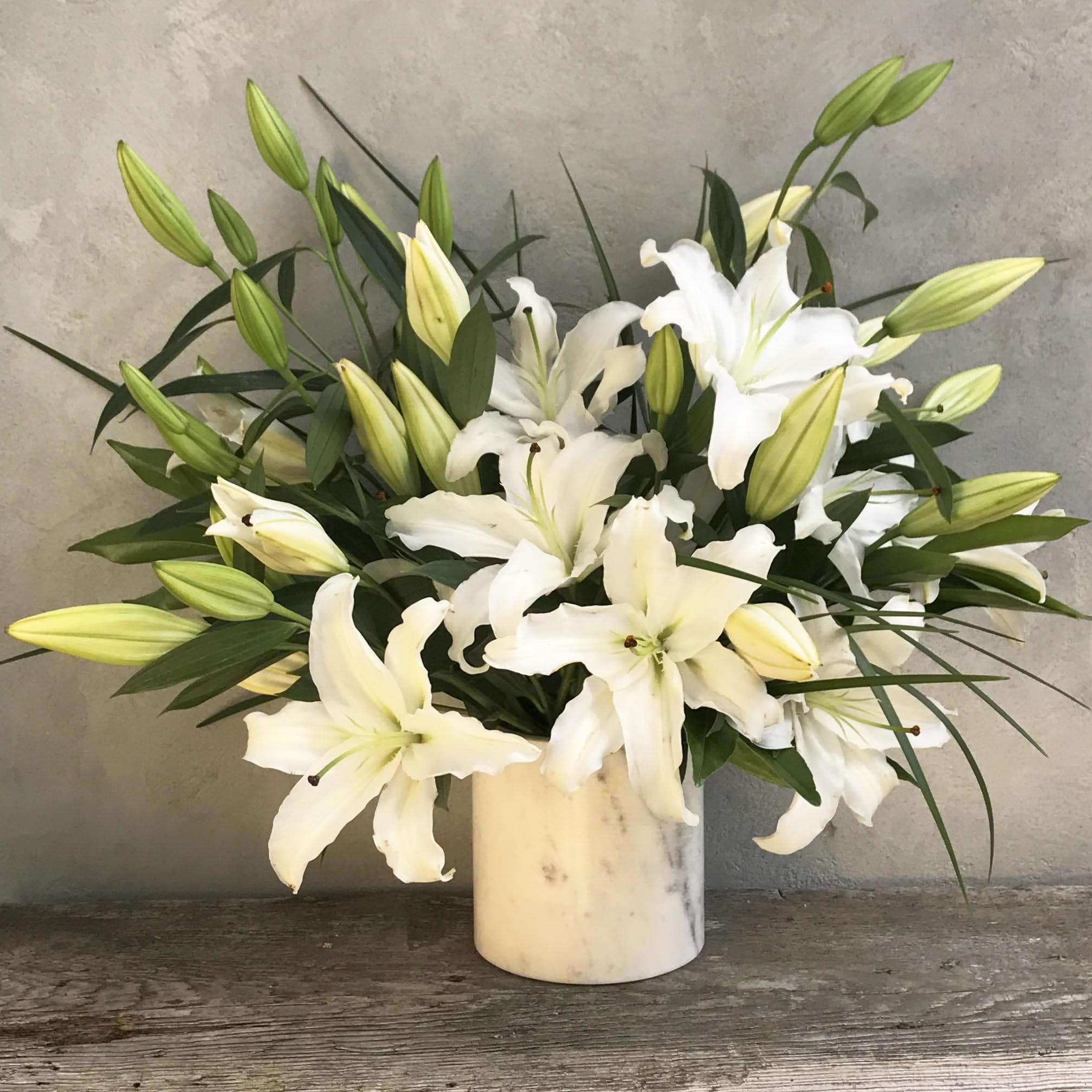 White Marble - An array of classic white lilies arranged in a modern marble vase * Vase substitutions may be applied*