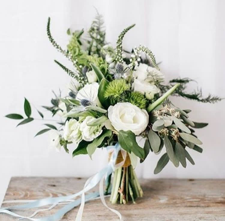 White and green bouquet with ribbon tied stems