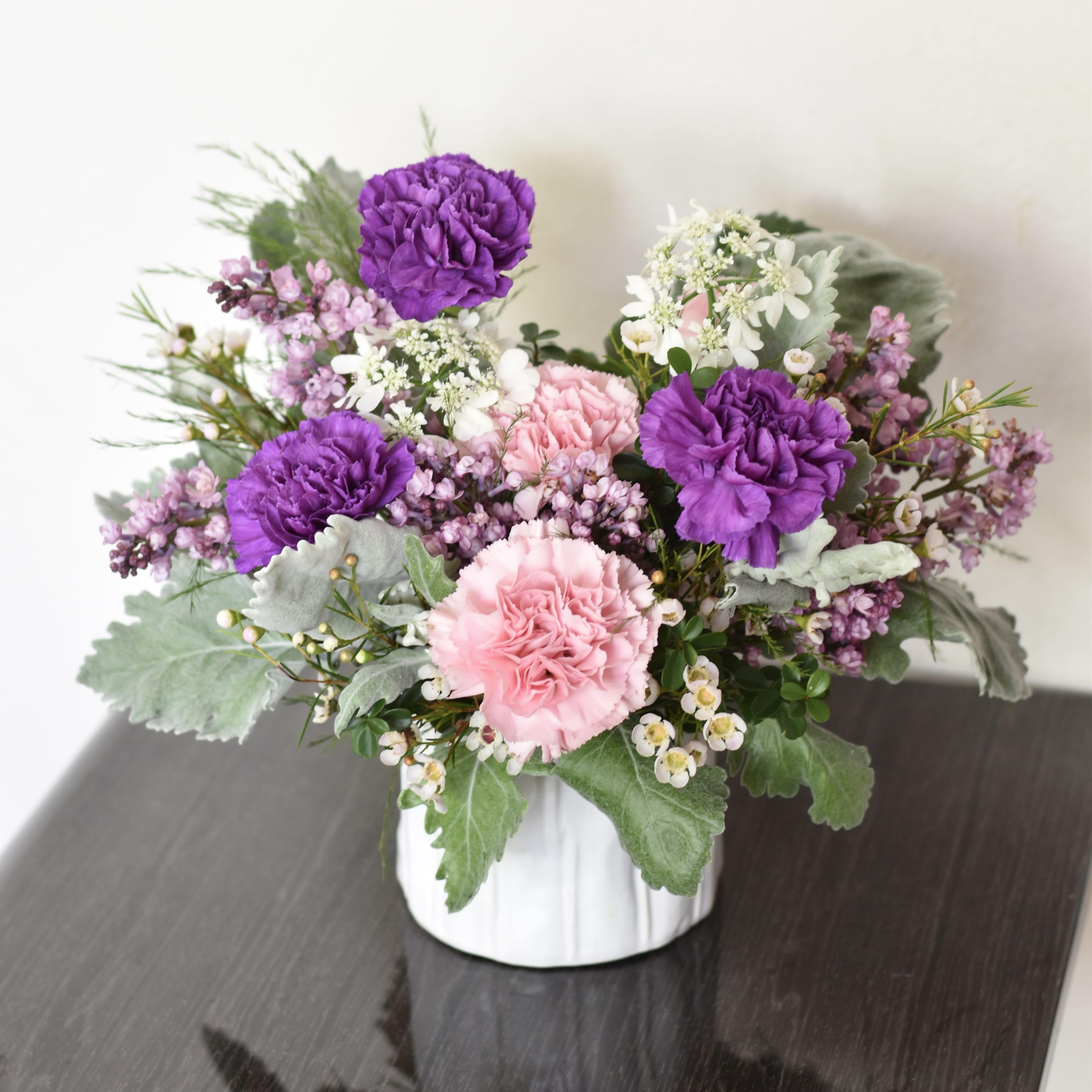 Mama's Love - Make this Mother's Day truly special with our enchanting floral arrangement, boasting a delightful blend of purple and pink carnations. Each bloom symbolizes the love, warmth, and appreciation we hold for mothers everywhere. Handcrafted with care by our skilled florists, this bouquet radiates beauty and tenderness. Whether it's to honor your own mom, a cherished grandmother, or any maternal figure in your life, our stunning arrangement is sure to convey your heartfelt sentiments. Order now for delivery and let the timeless elegance of carnations make this Mother's Day unforgettable.