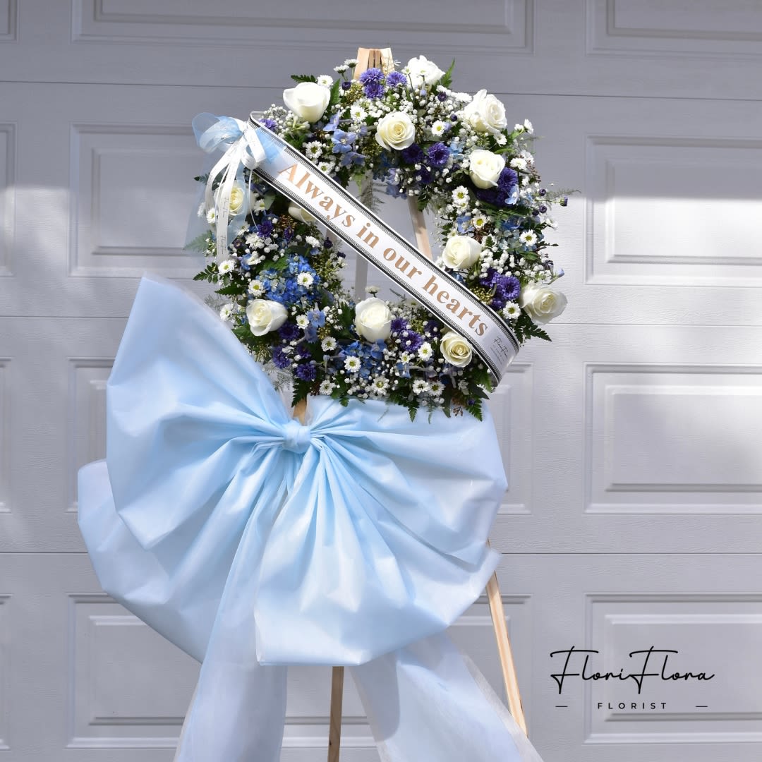 Blue Wreath - -18 inches Wreath or 24 inches Wreath Include: - 1 wooden stand 66 inches - 2 free Banners (Max 8 Words each Banner) To Add BANNER MESSAGES ===Please Copy and Paste Below into "Special Instruction" box === Banner 1: (message here) Banner 2: (message here)  *****Please note that this wreath has to order in advance 2 days before delivery date.*****