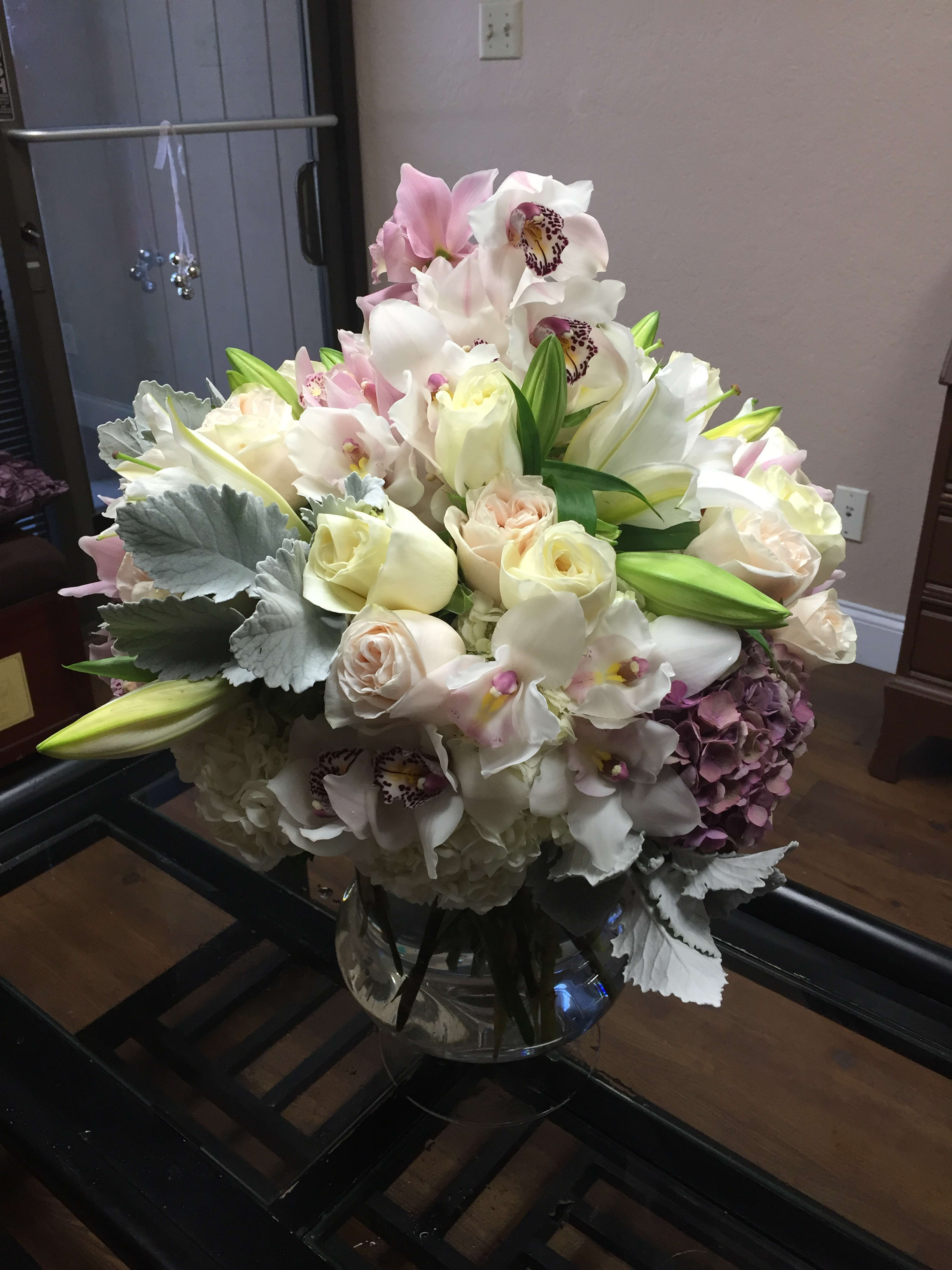 Bouquet of white and blush flowers in a glass vase