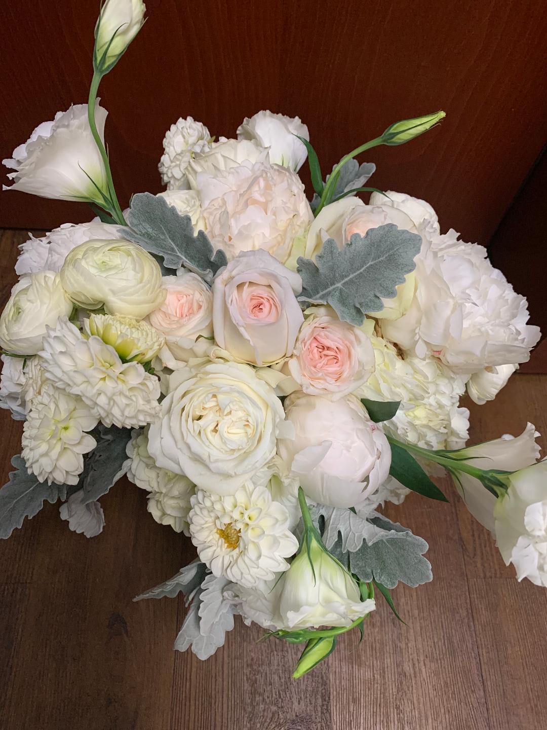 White and blush bouquet with roses, ranunculus, and lisianthus