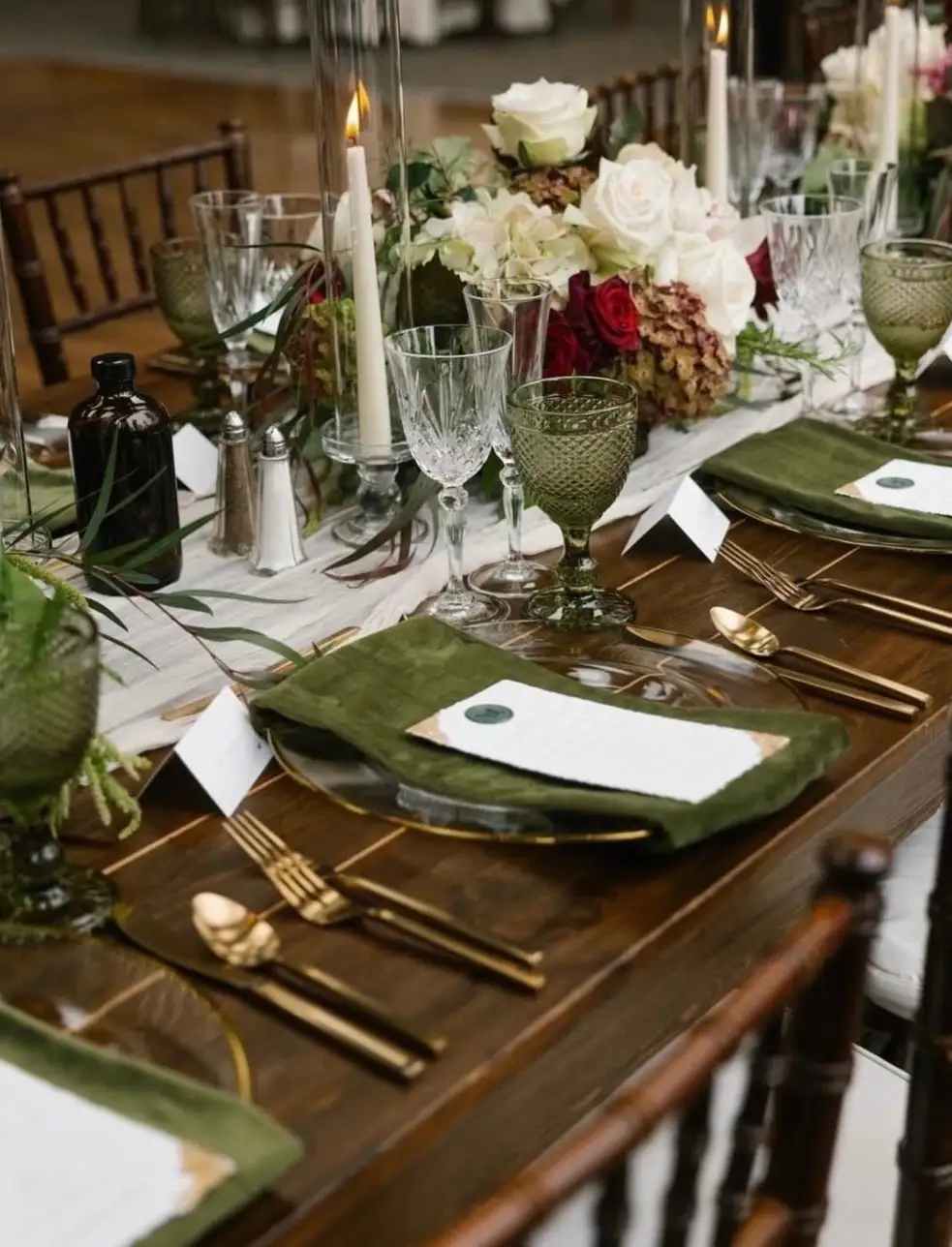 Floral table centerpiece with white and red roses on a set dining table