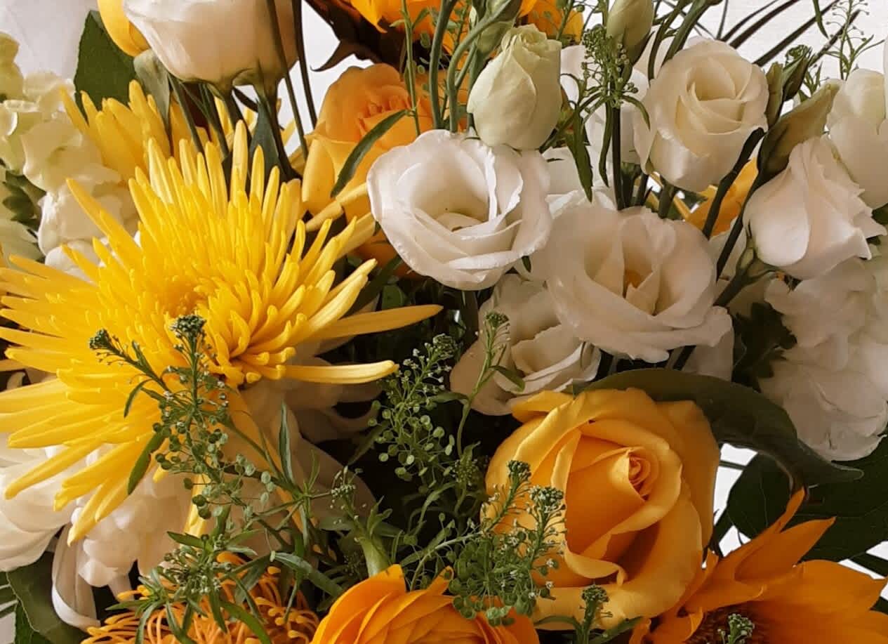 Bouquet of yellow and white flowers with orange roses