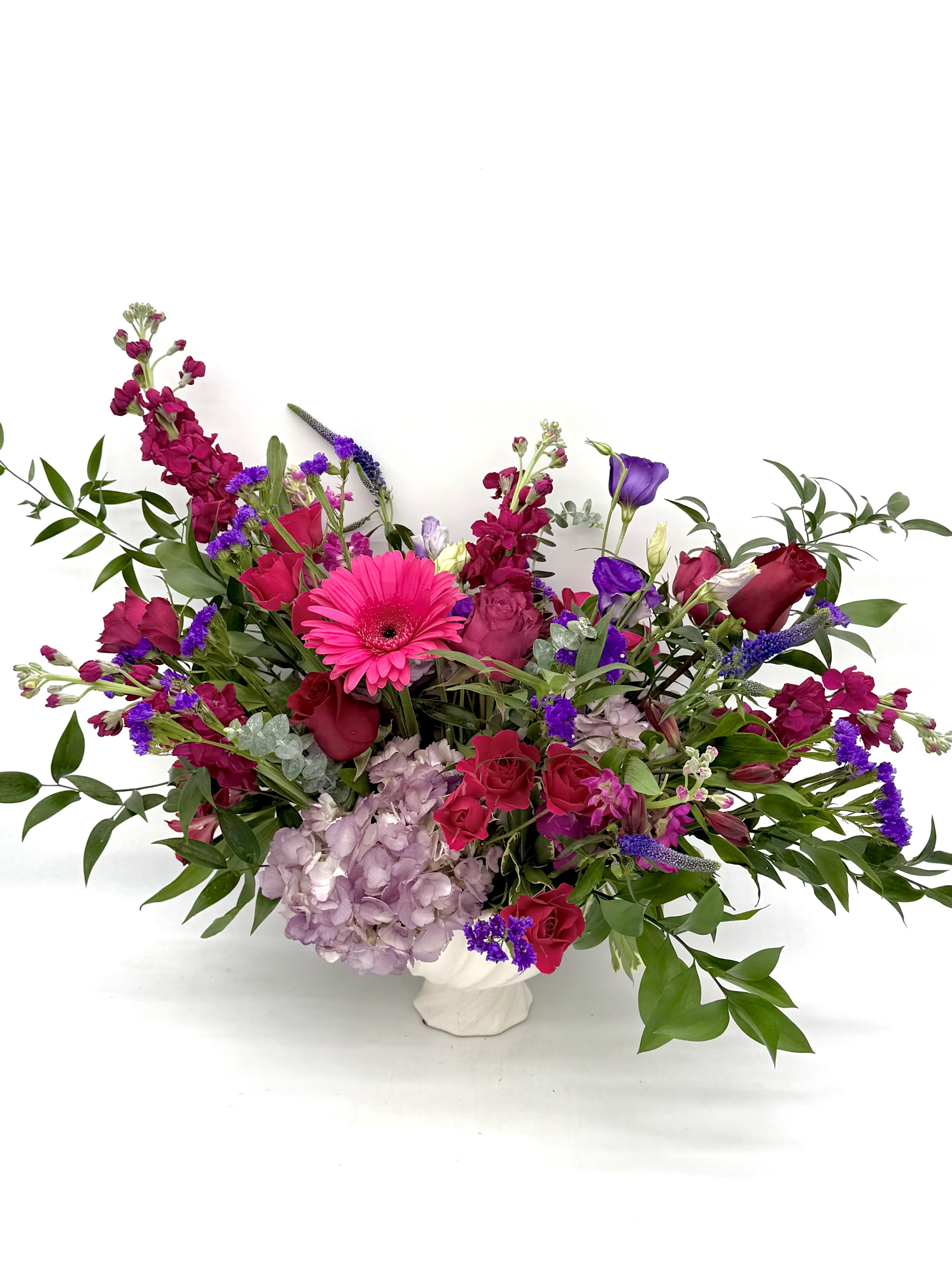 Cherry Berry Centerpiece - A lavish celebration of berry tones, Cherry Berry Centerpiece overflows with velvety reds, deep violets and fuschias. Designed with a garden-inspired silhouette in a sleek modern compote, you will find layers of texture, movement colors that are full of life. Bold yet effortlessly refined, this centerpiece turns everyday moments into something worth celebrating.