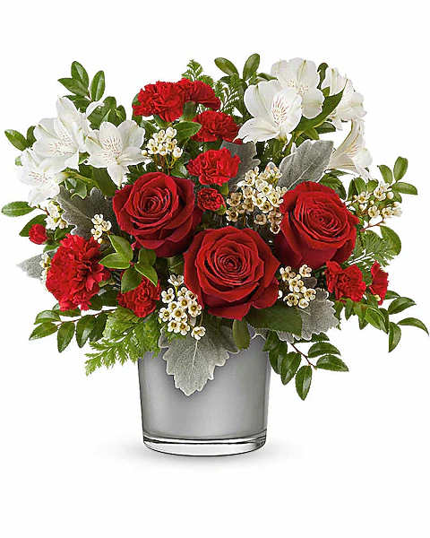 Red roses and white flowers arranged in a gray glass vase