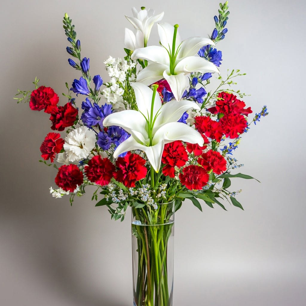Rising Stars - Classic and proud, this fresh arrangement brings the spirit of July 4th to life with rich color and elegant blooms.