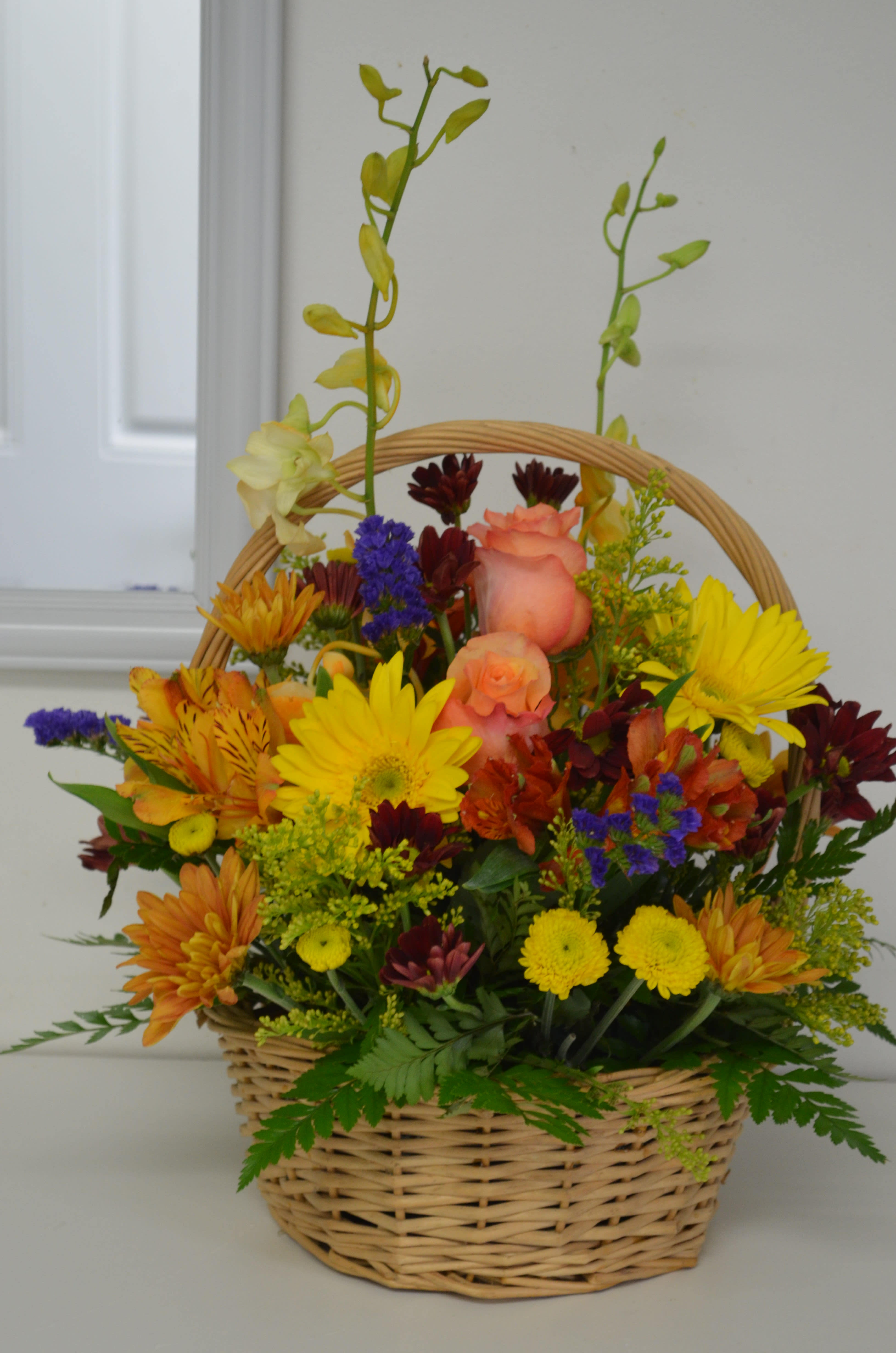 Mixed flower basket with roses, daisies, and chrysanthemums