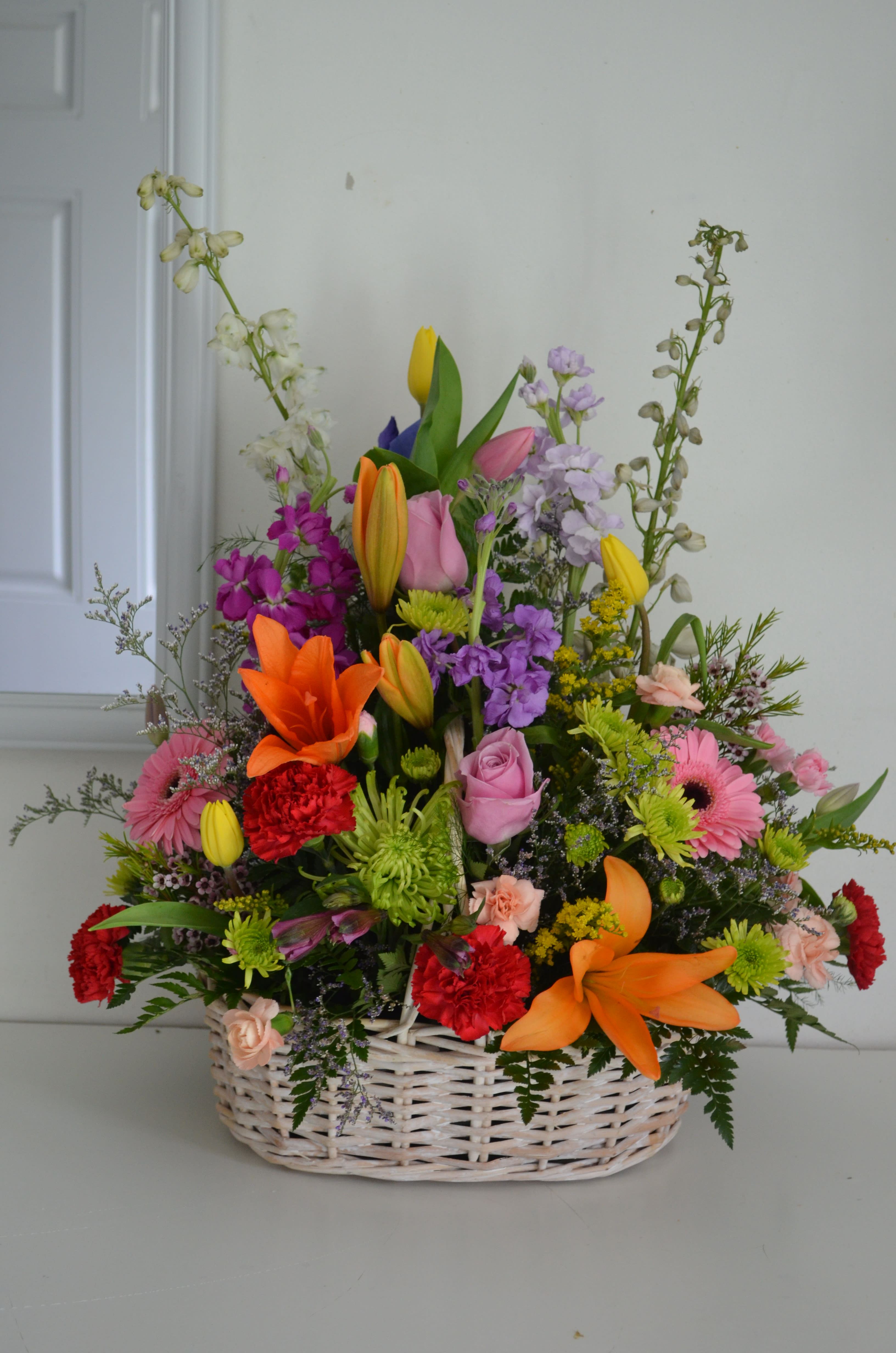 Mixed flower basket with lilies, roses, gerberas, and carnations