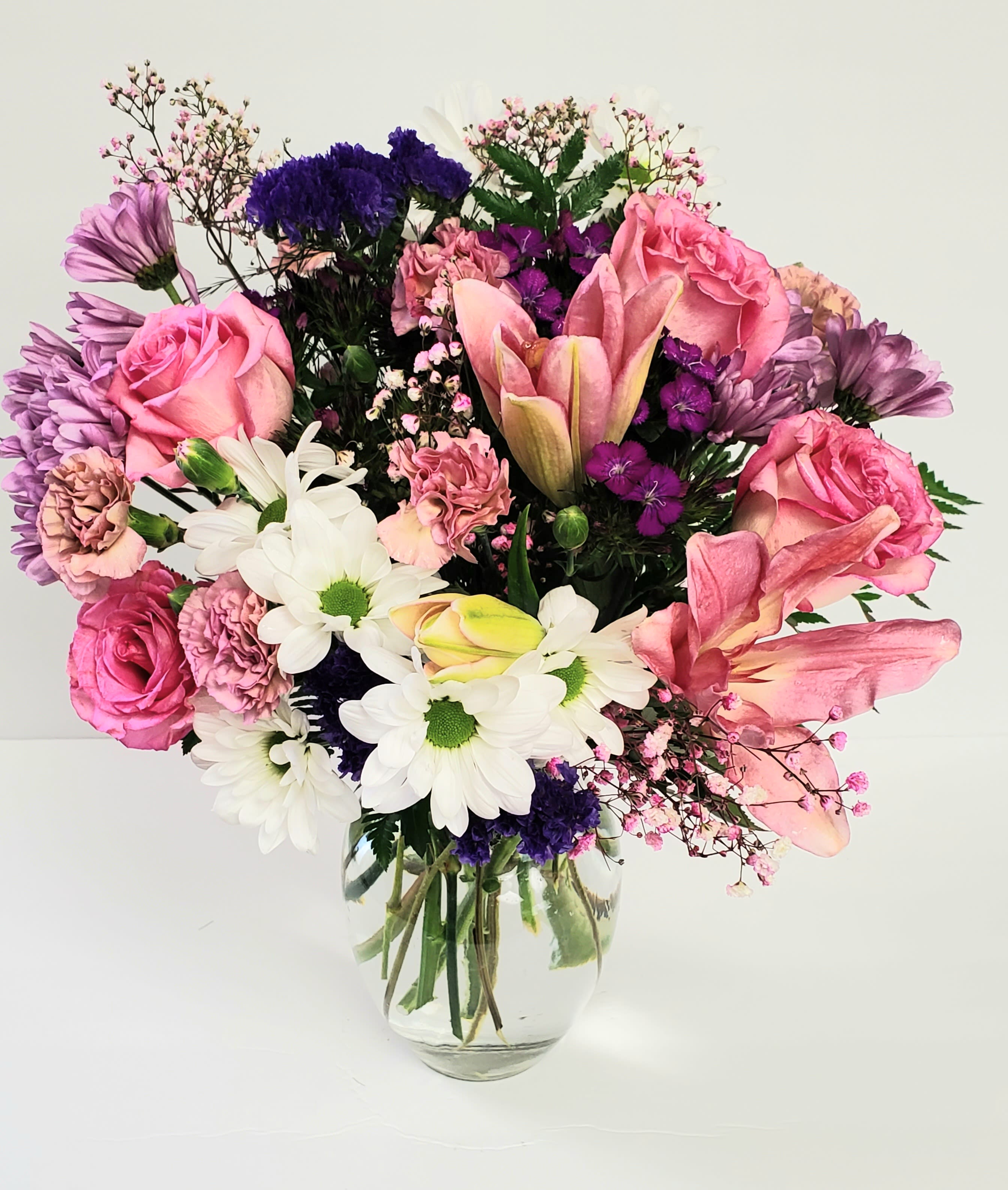 Pink and purple mixed bouquet in a clear glass vase