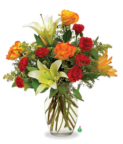 Bouquet of orange roses, red carnations, and white lilies in a glass vase