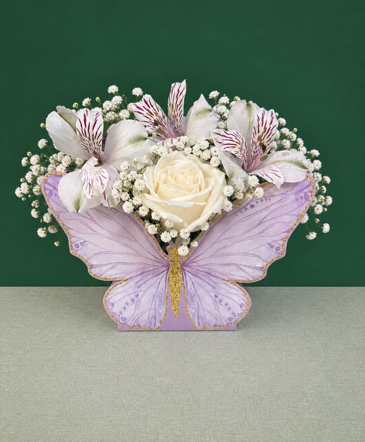 Butterfly Bloom Box - A charming butterfly-shaped floral box featuring fresh roses, delicate accent flowers, and baby’s breath. This elegant keepsake is perfect for birthdays, Mother’s Day, anniversaries, or any special occasion. Flower colors may vary based on seasonal availability.