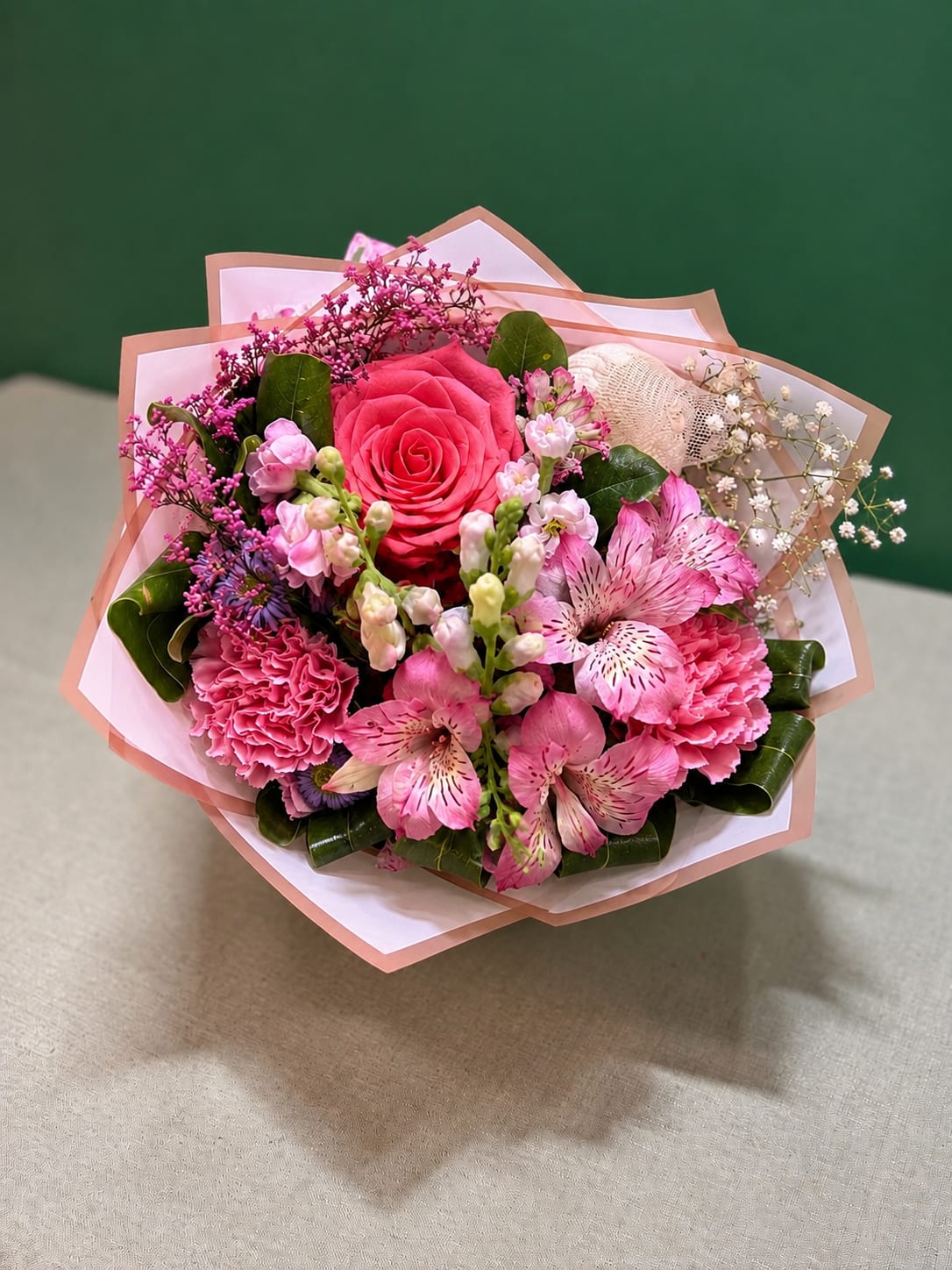 Sweet Elegance Grab and Go - A charming grab-and-go floral arrangement featuring a premium rose, alstroemeria, carnations, snapdragons, and seasonal accent flowers, thoughtfully arranged and wrapped in an elegant paper with a ribbon. Perfect for birthdays, anniversaries, thank-you gifts, or simply brightening someone’s day. 