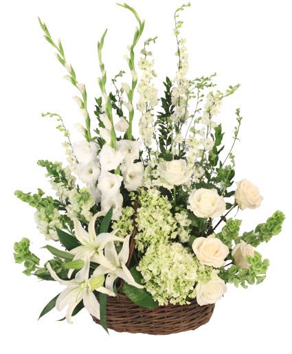 White floral arrangement in a wicker basket with tall stems