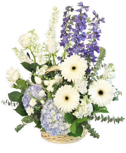 Basket arrangement with white roses, gerbera daisies, and purple flowers