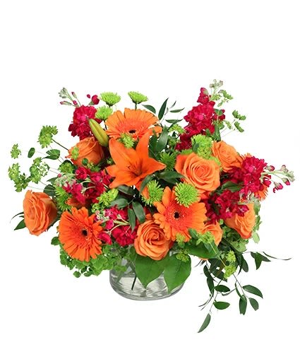 Orange Explosion  - Bursting with Orange! Roses, lilies paired with purple stock and greeneries. 