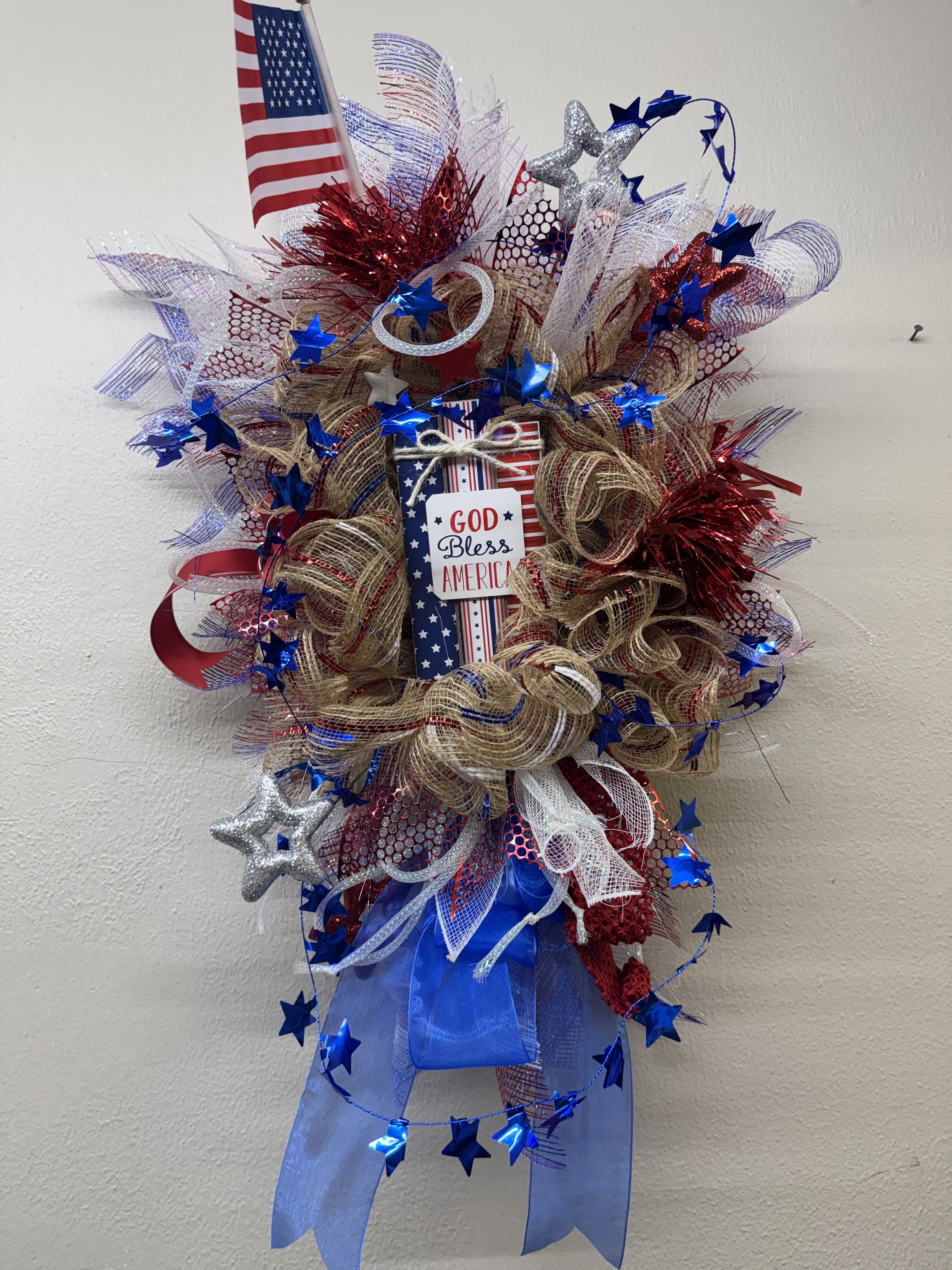 Firecracker Door Swag - Door swag designed with ribbons, mesh and other Patriotic decor. Perfect for your front door! 