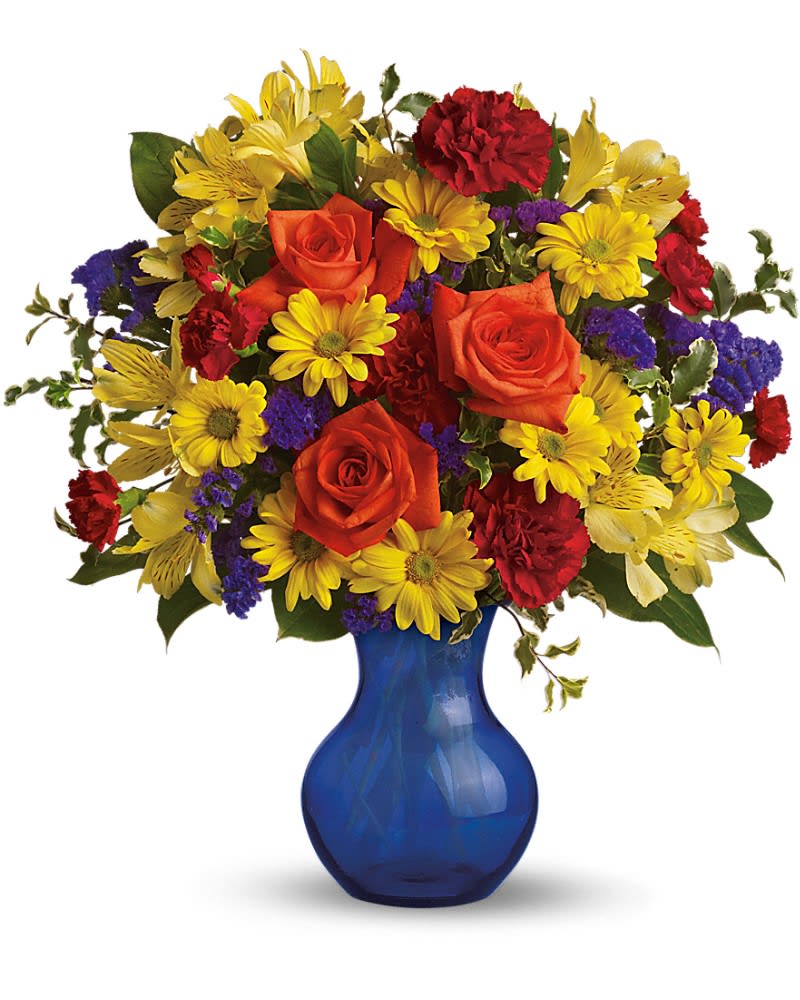 Mixed bouquet of red roses, yellow daisies, and purple filler in a blue vase