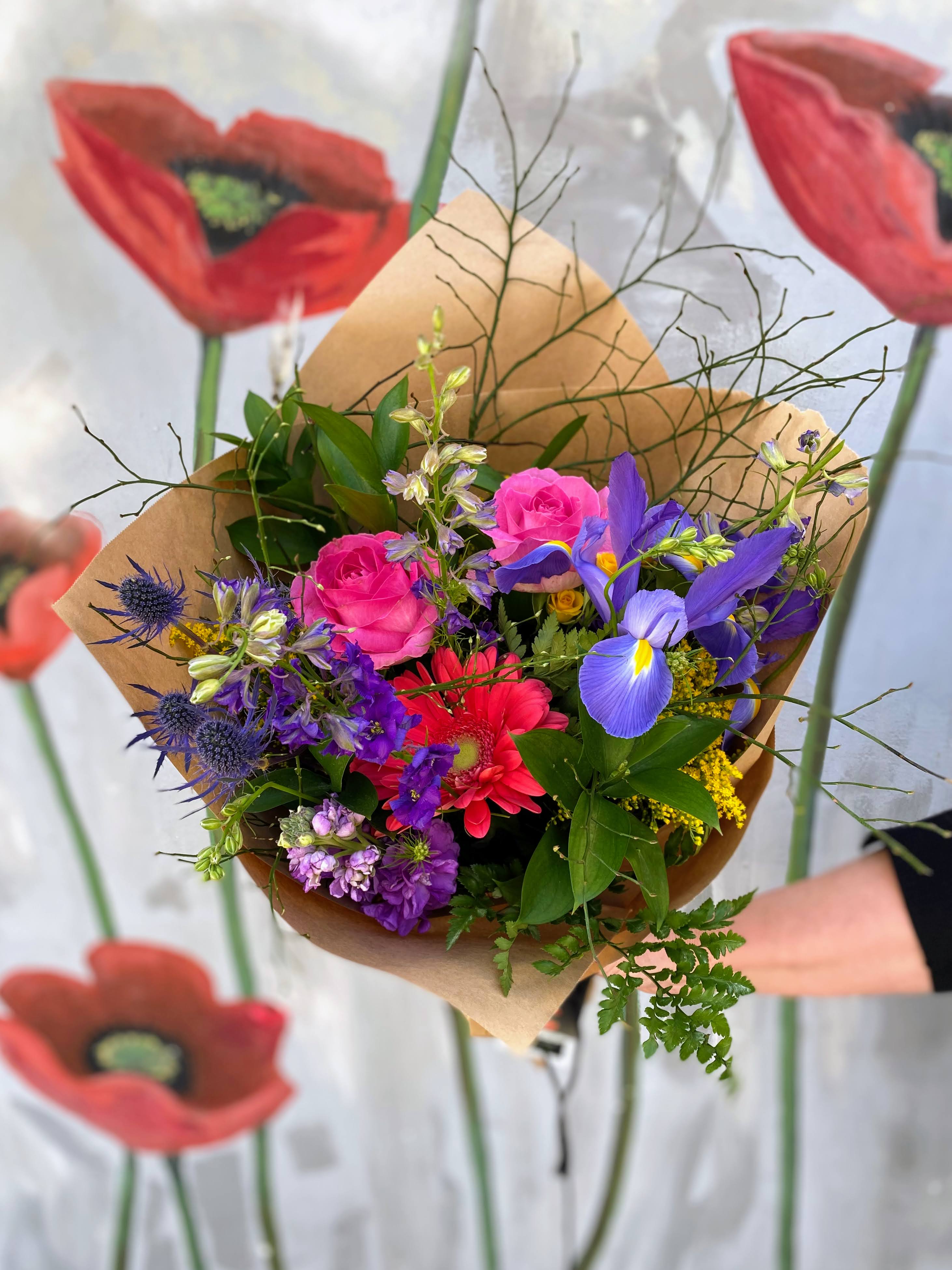 Hand-Tied Bouquet - A bright mix of seasonal flowers that are wrapped up to go into the recipient's vase.   Don't forget to add our deluxe wrapping option for that extra special look ;)