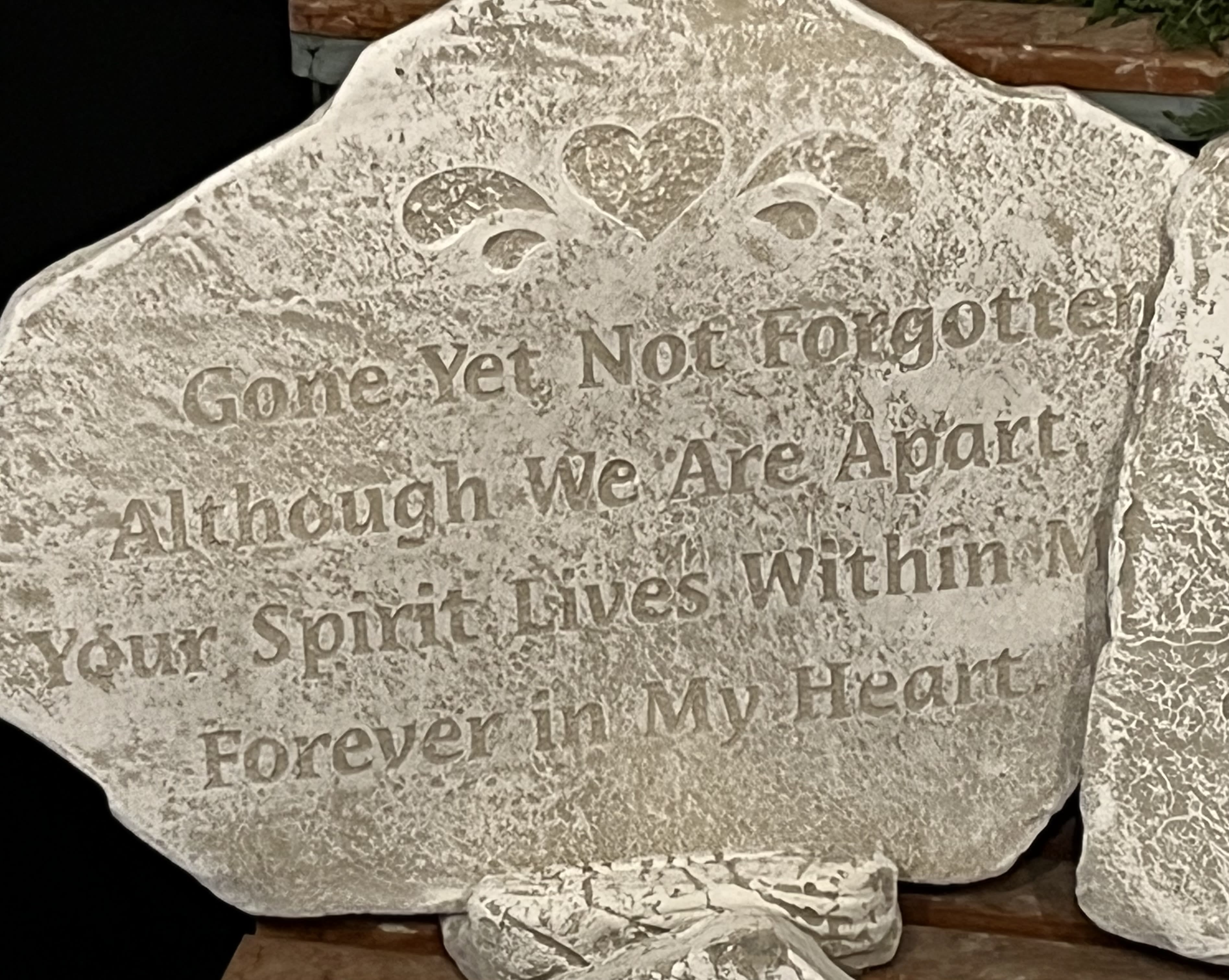 Decorative stone plaque with a heart and engraved quote