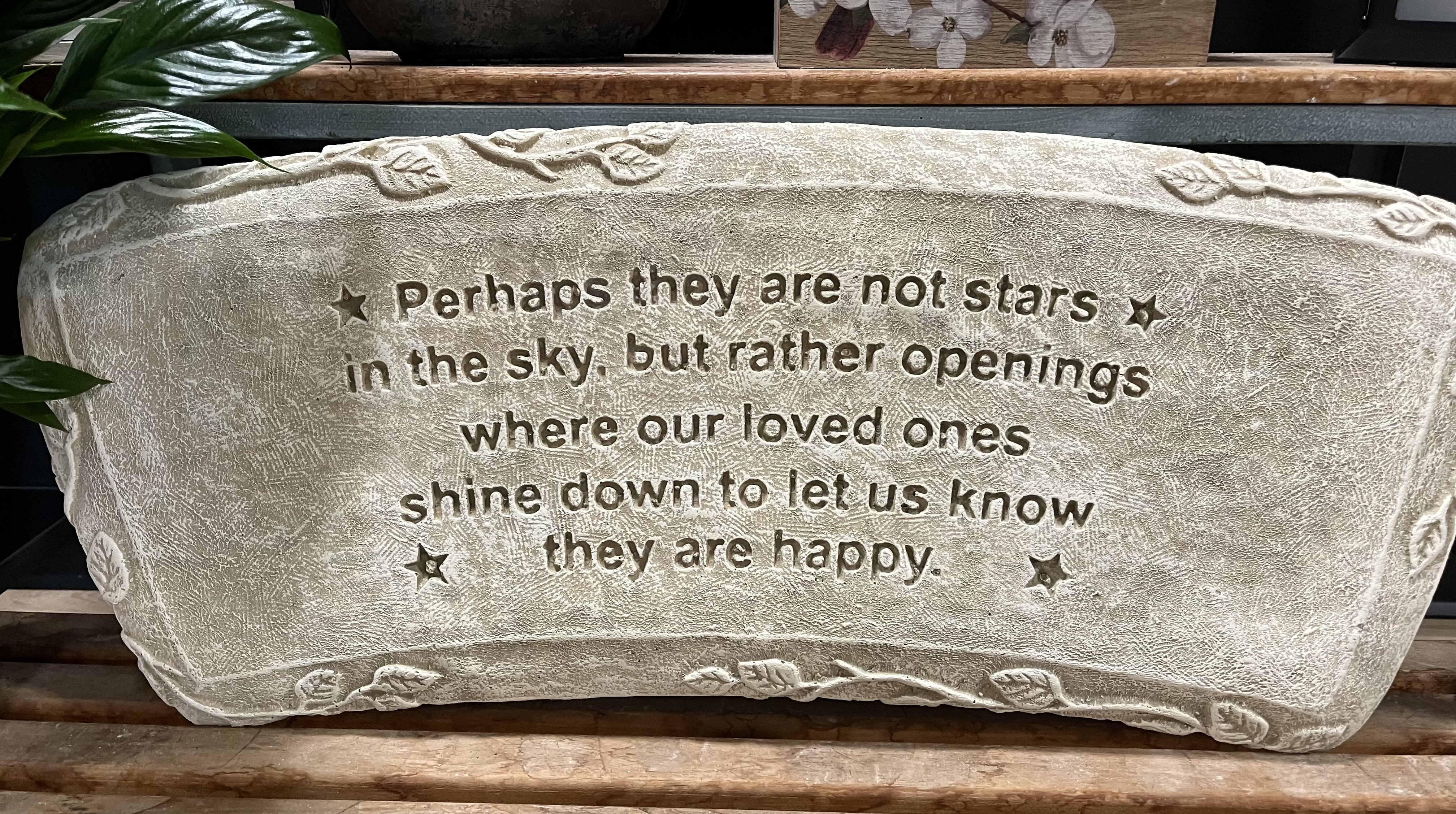 Rectangular stone memorial plaque with engraved sympathy quote and small star accents.