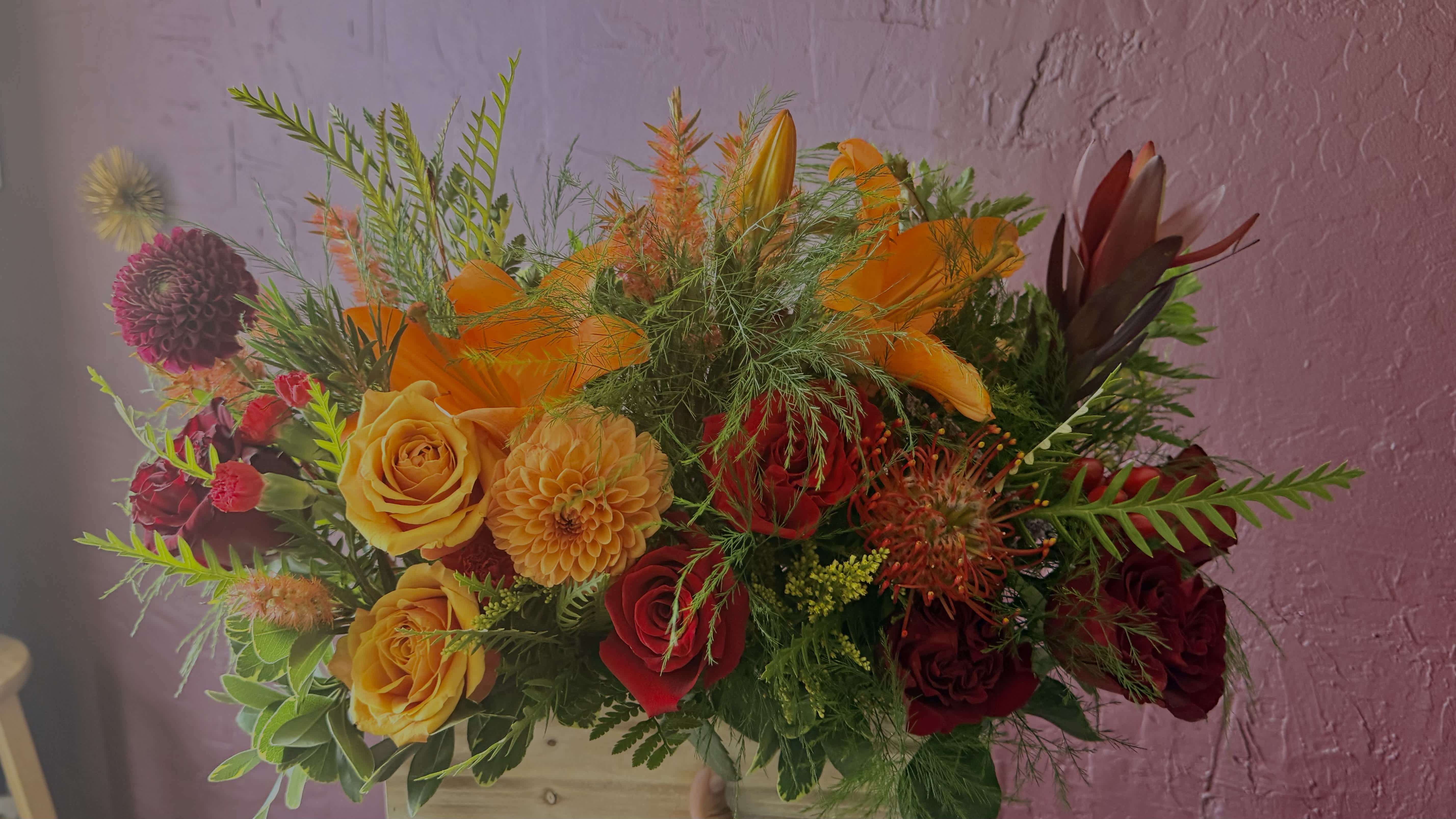 Bright mixed bouquet with orange, yellow, and red flowers