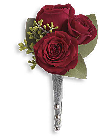 Three red roses arranged as a boutonniere with green accents and a silver-wrapped stem