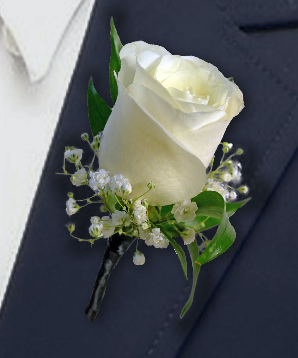 White rose boutonniere with baby's breath and green leaves