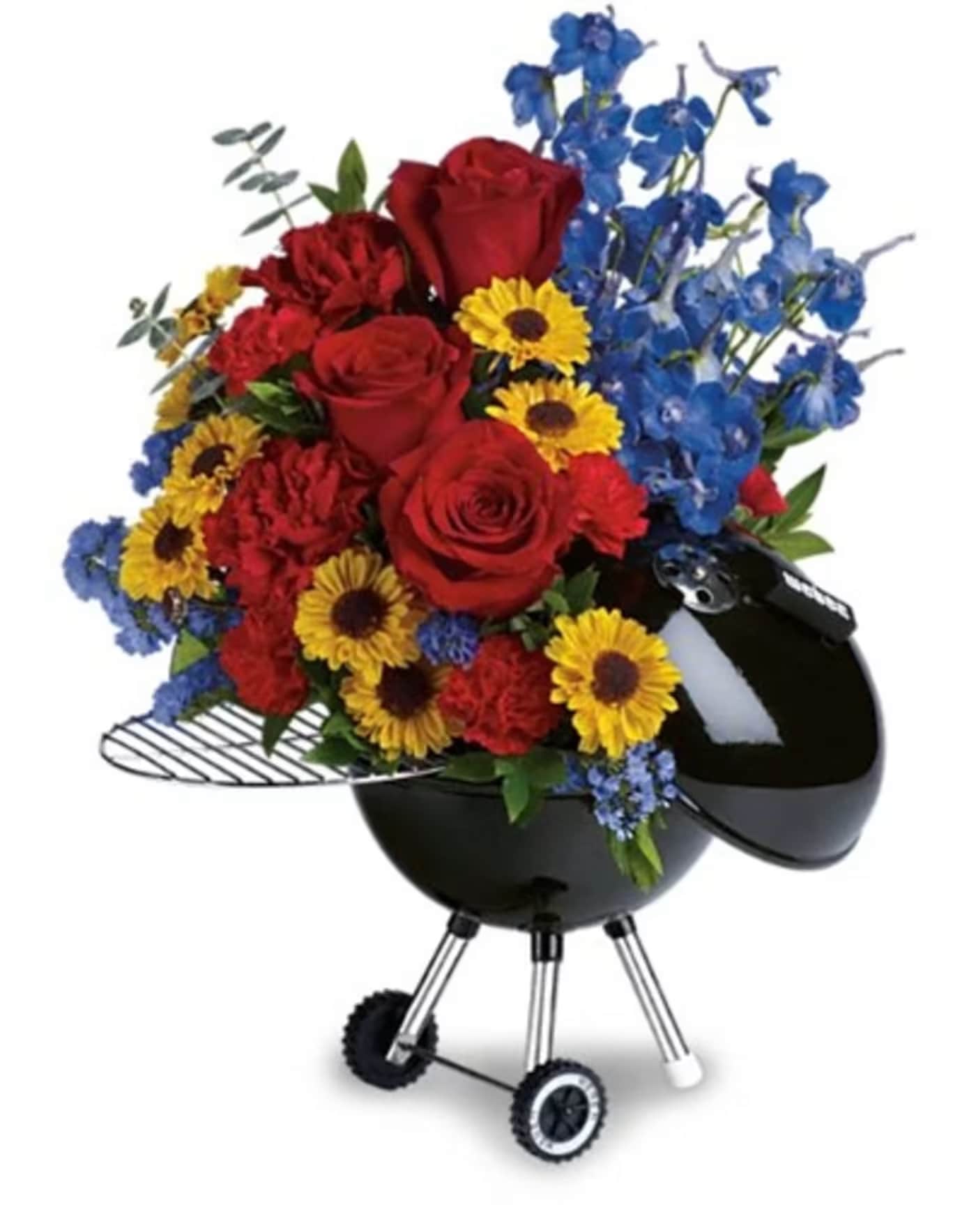 Dad's BBQ Day - A playful barbecue-themed floral arrangement built to make Dad (or any grill master) grin: vivid red roses and sunny yellow spray roses are packed into a black kettle grill-shaped container, topped with tall purple stock for vertical movement. Perfect as a Father's Day gift, birthday surprise, or a cheerful congratulations bouquet, the bold red, yellow, and violet palette reads festive and confident - the kind of arrangement that says "you're celebrated" to the person you're thinking of.  This design combines red roses, purple stock, yellow spray roses and mixed greenery with fern-like foliage and broad leaves that soften the composition and add texture around the base. The novelty hard goods - a black grill container with a metal grate, visible wheels, and supporting legs - give the arrangement an unmistakable BBQ look and a sturdy presentation that works as a table centerpiece or front-porch surprise. Size and exact stem counts vary by availability; to keep blooms looking their best, place in a cool spot away from direct sun and refresh the water if the arrangement includes a water source.