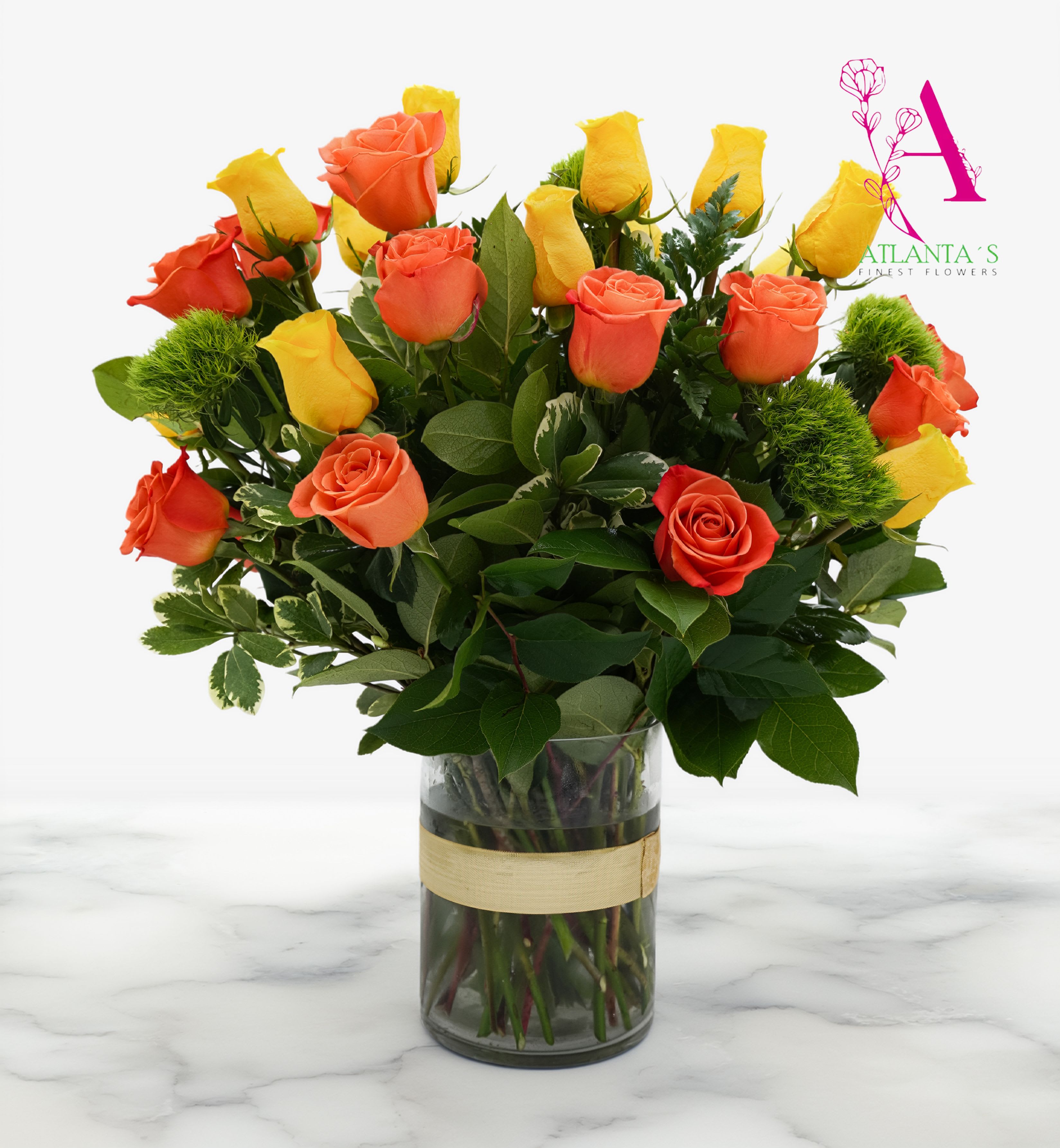 Gold 'N' Rosy - A lively cluster of yellow, peach, and orange roses makes a joyful statement - perfect as an anniversary bouquet or a bright birthday surprise. Gold 'N' Rosy is a rounded, full-silhouette flower arrangement that reads warm and uplifting, the kind of gift that makes the person you're thinking of feel genuinely celebrated whether you're marking an autumn milestone or a springtime hello.  Twenty-four specialty roses are arranged at varied heights with camellia and Italian ruscus for texture and abundant greenery, sitting in a clear glass vase finished with an orange ribbon. The mixed warm palette (red, yellow, peach, orange, pink, and green accents) keeps the look versatile for get well wishes, a thoughtful "I'm sorry," Women's Day, or a simple just-because moment. Arrives ready to display; refresh water daily and trim stems every few days to extend vase life.