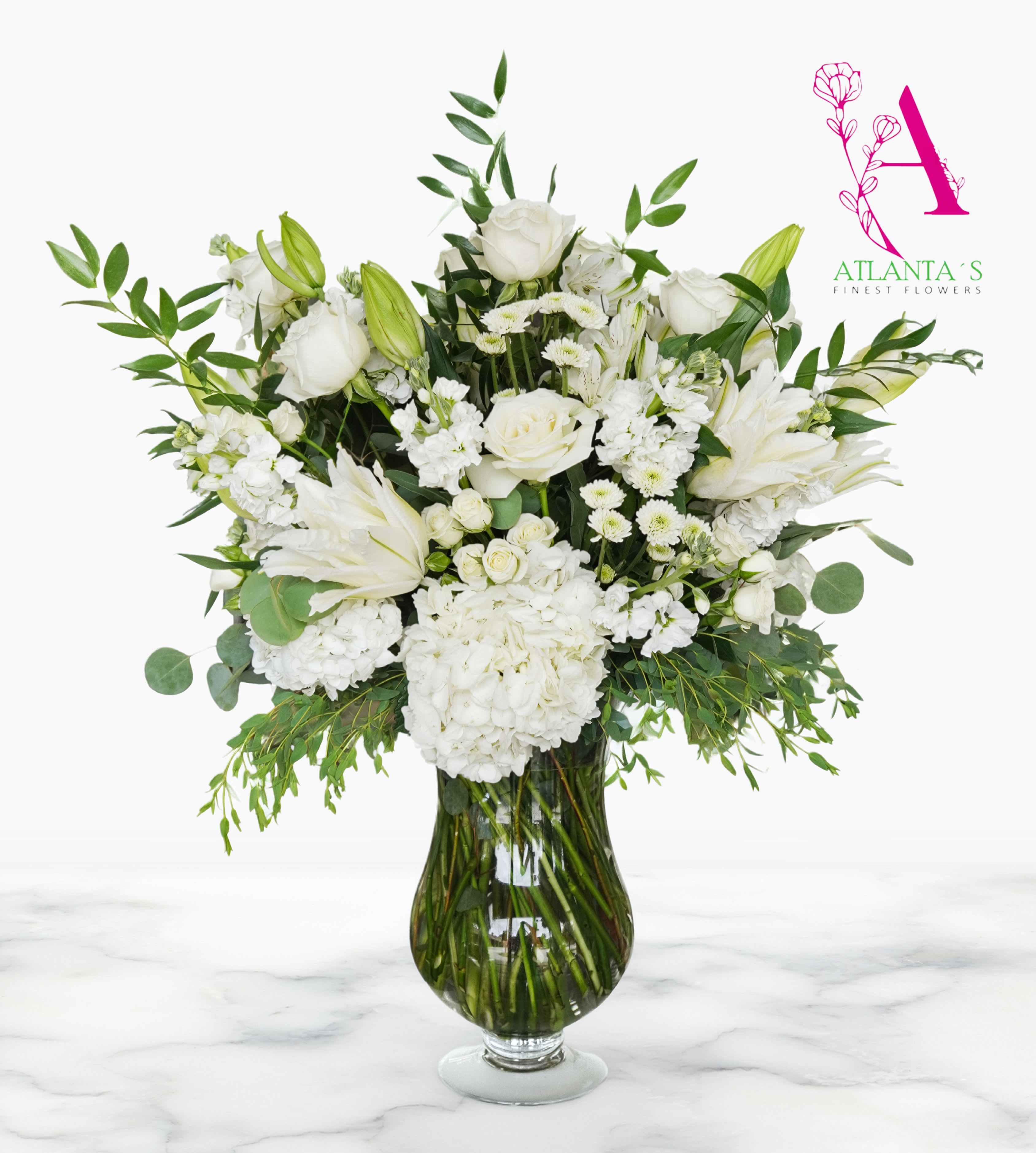 Purest Love Bouquet by Atlanta's Finest Flowers  - This Purest Love bouquet includes hydrangea, asiatic lilies, alstroemeria, miniature carnations, stock and fresh green pittosporum. Delivered in clear urn vase 