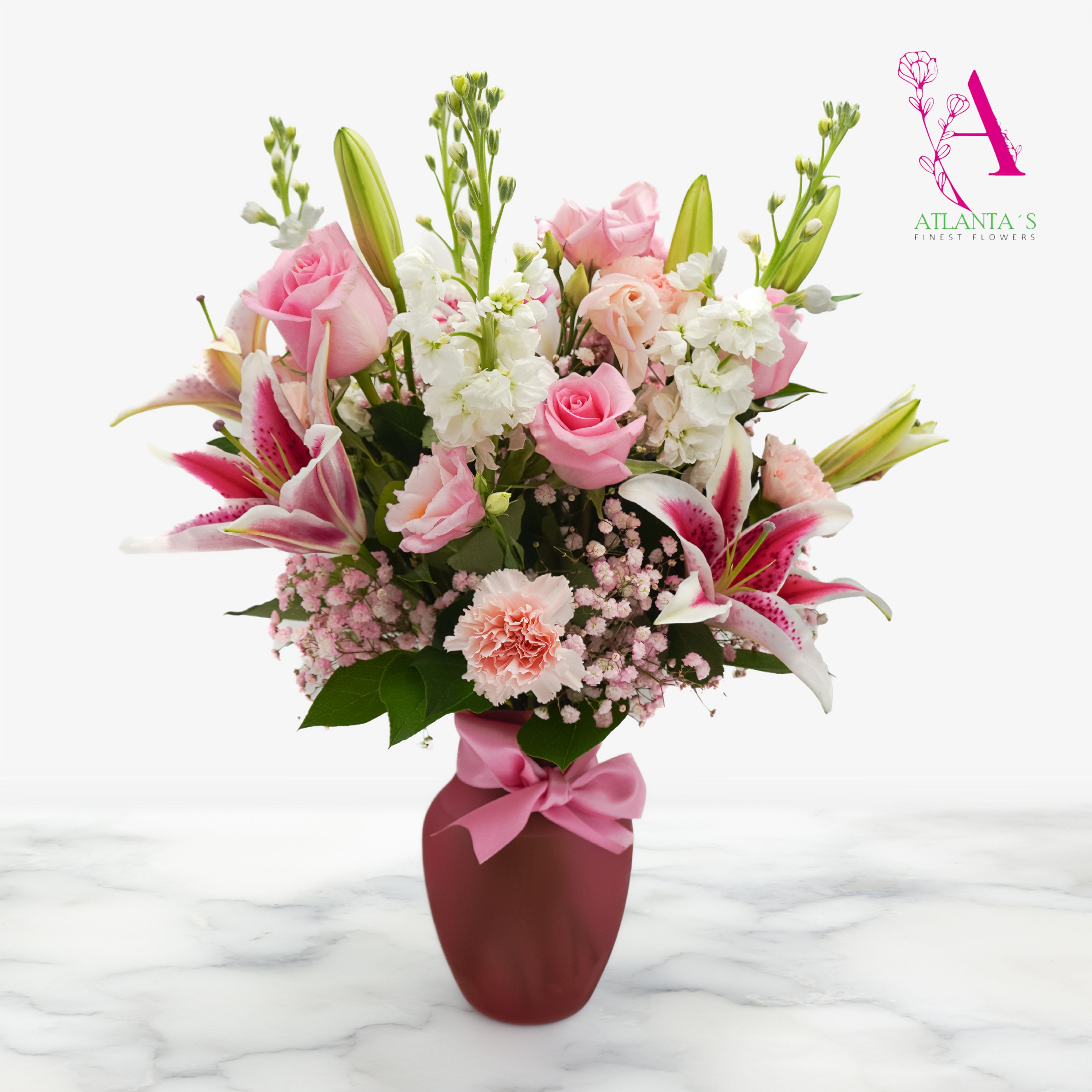 Blushing Lily Love - Soft, elegant, and full of charm, this arrangement features graceful pink lilies paired with a lush mix of pink-toned blooms and white florals. Designed to bring warmth and beauty to any space. Perfect for celebrations, mother's day, or simply brightening someone’s day with a touch of pink perfection.  Vase Size:  8"H x 6"W 