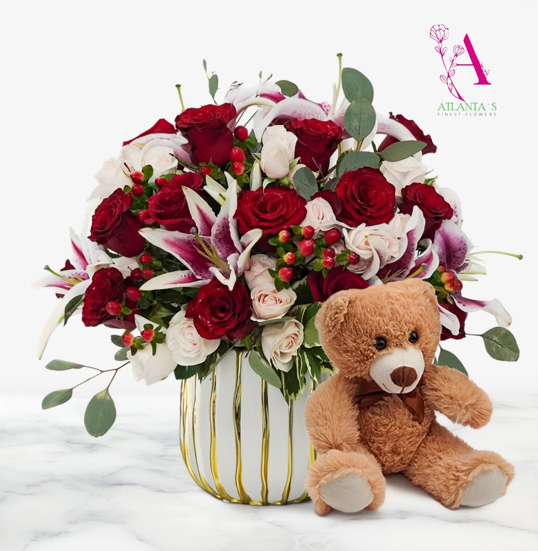 Roses &amp; Lilies with a Bear by Atlanta's Finest Flowers   - A mix of red, pink roses, and white lilies, accented with fresh greenery and berries, all arranged in a modern white and gold vase plus a cuddly teddy bear on the side. Perfect for celebrating love, just because, and much more.  Flower are arranged in a White and Gold Vase  13" Teddy Bear Is INCLUDED 