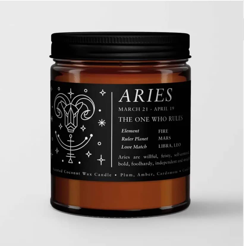 Amber candle in a black-lidded jar with an Aries label