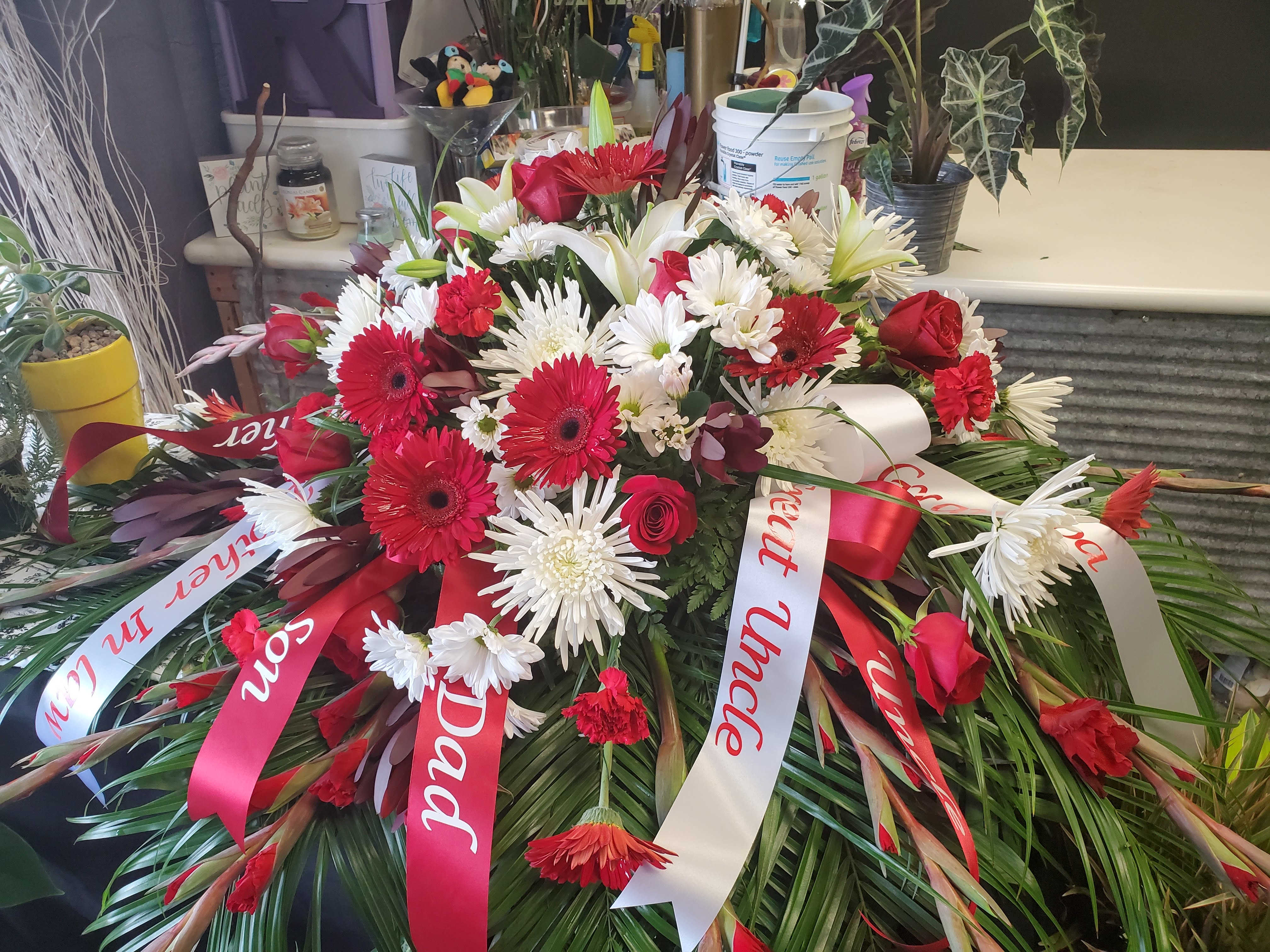 Large red and white funeral spray with ribbons